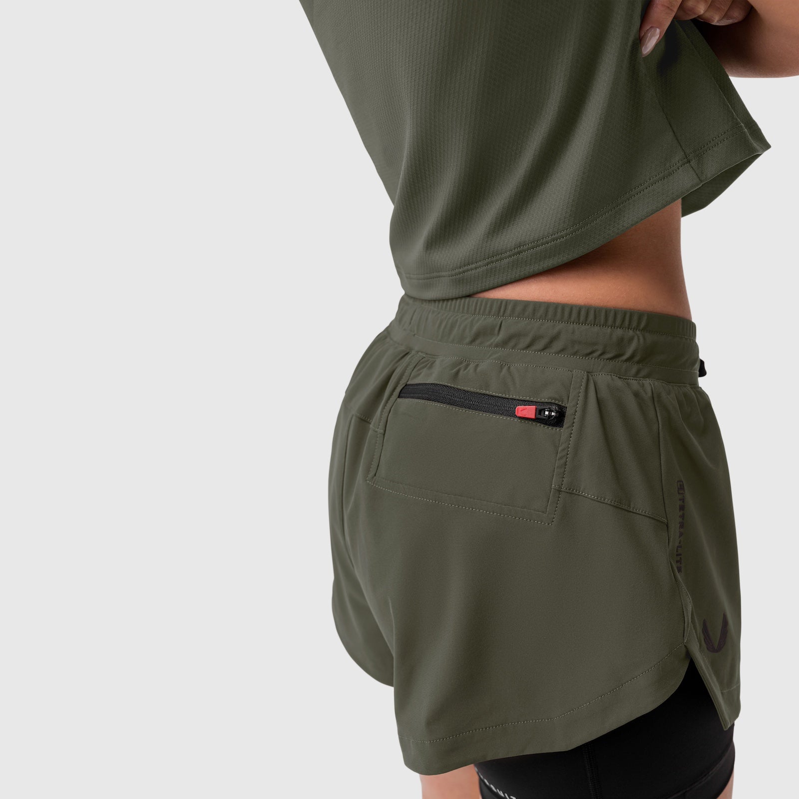 Tetra-Lite® Liner Short in olive worn by model, back view showing pocket detail
