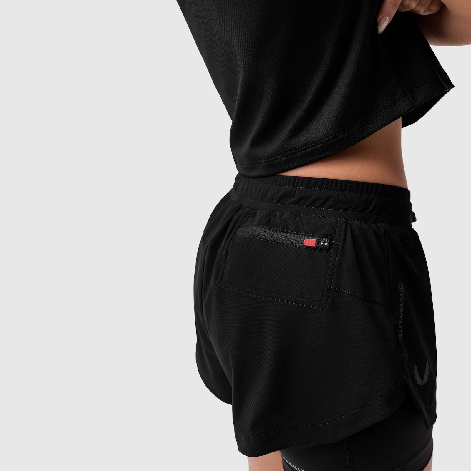 Tetra-Lite® Liner Short in black worn by model, back view showing pocket detail