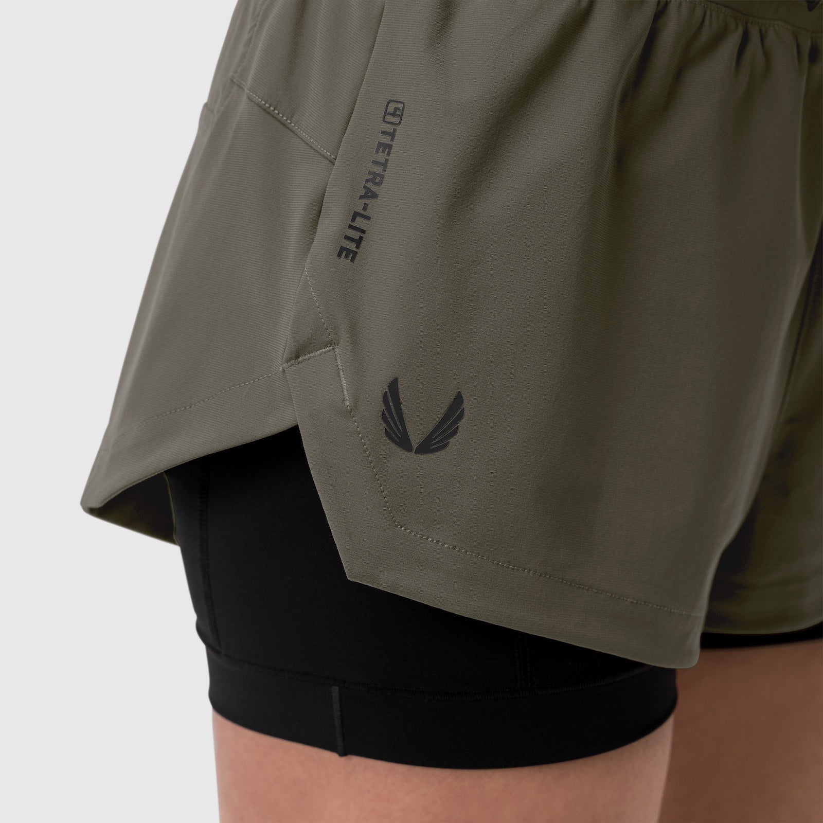 Tetra-Lite Liner Short in olive worn by model, side detail showing pocket and logo