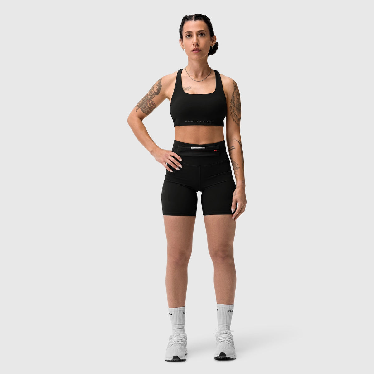 Black LYCRA® 3-in-1 biker shorts worn with matching sports bra, front-facing pose