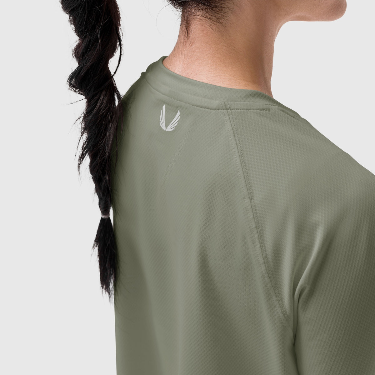 AeroSilver® Cropped Tee in sage worn by model from back, showing logo detail