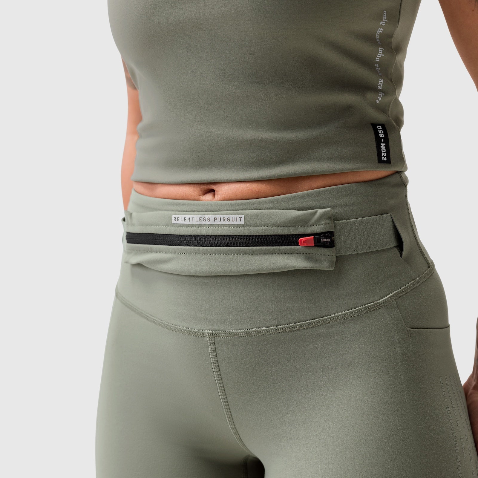 W030 Lycra 3-in-1 Legging in sage, worn with integrated belt bag, front view