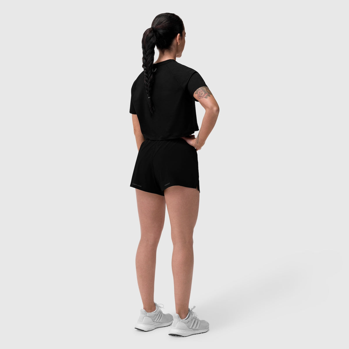 Black AeroSilver Cropped Tee worn by model, back view, paired with black shorts