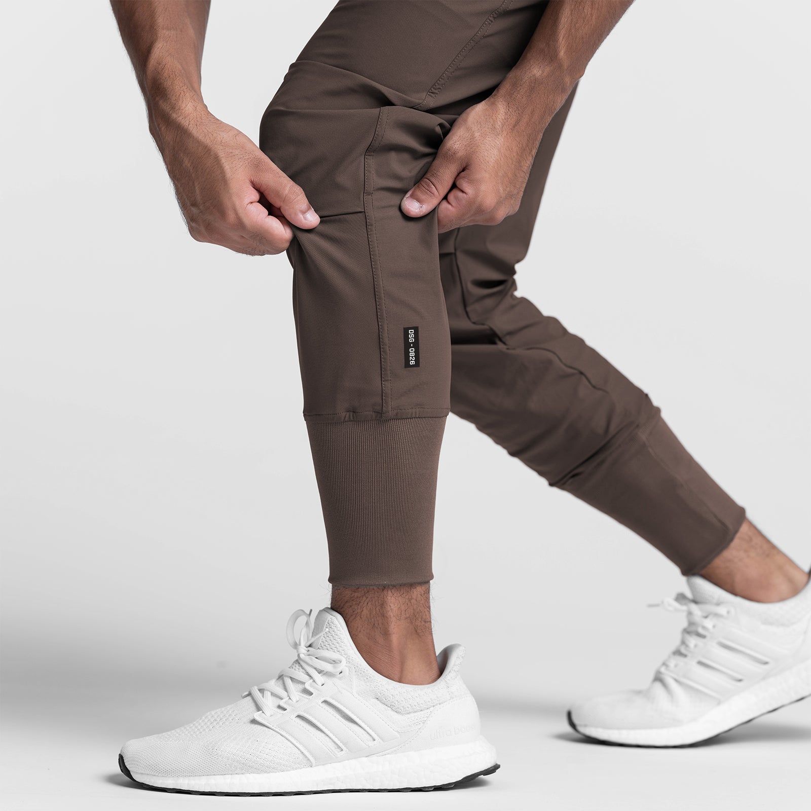 Tetra-Lite High Rib Jogger in deep taupe worn by model with white sneakers, side view