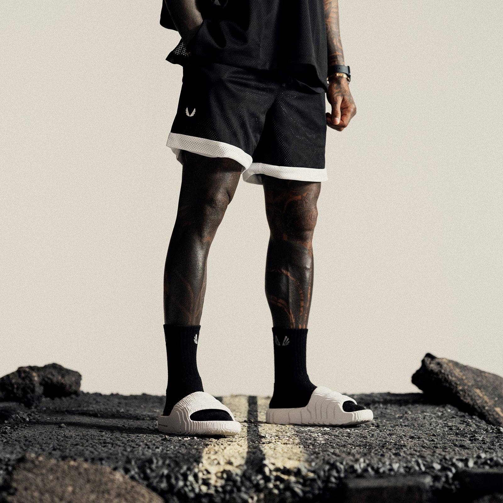 SilverPlus™ Mesh Reversible Short in Black/White, worn by model standing on pavement