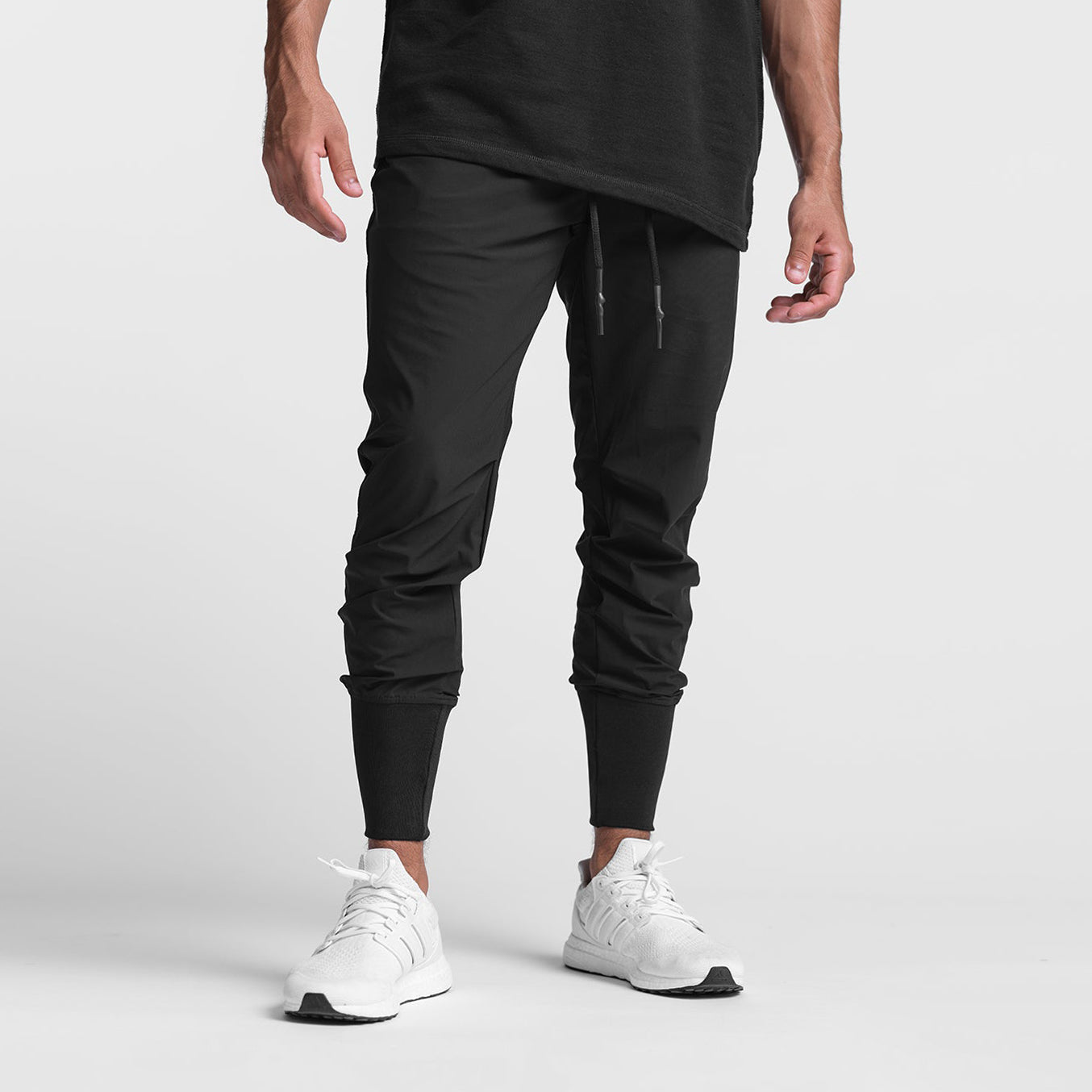Black Tetra-Lite High Rib Jogger worn by model with white sneakers, front view