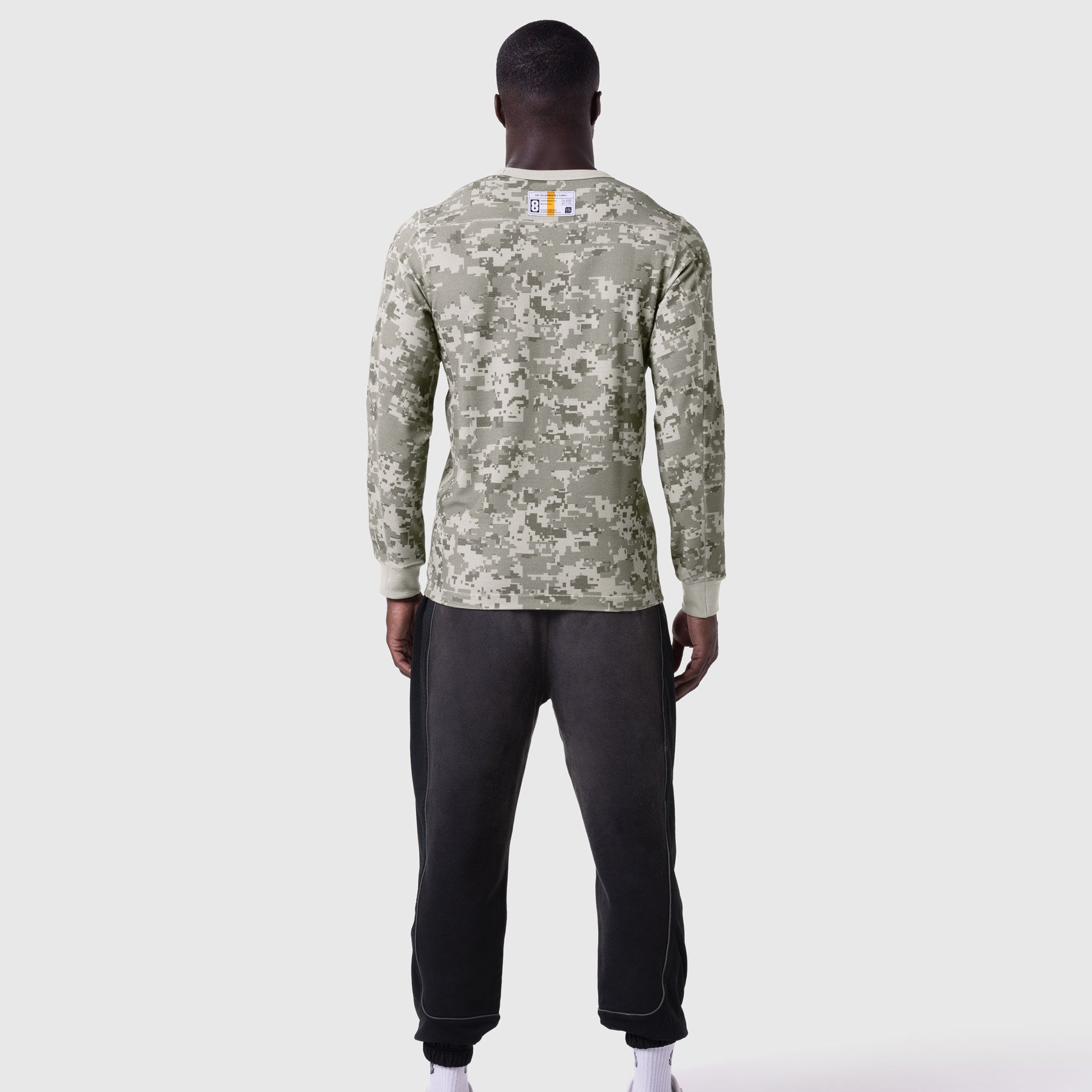 Digital camo waffle knit longsleeve worn with black joggers, back view