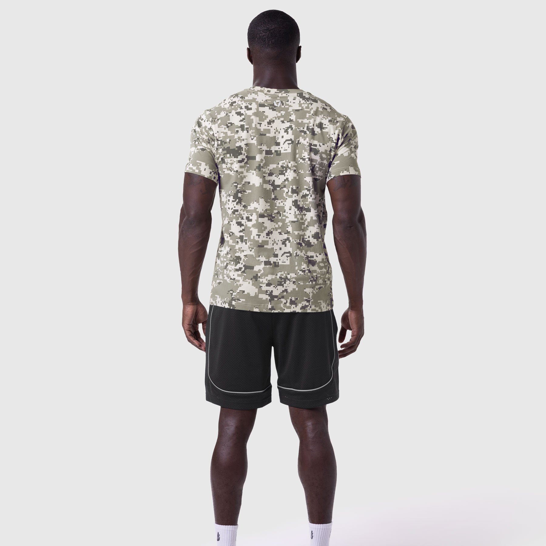 Supima Essential Tee in digital camo worn by model from back, paired with black shorts