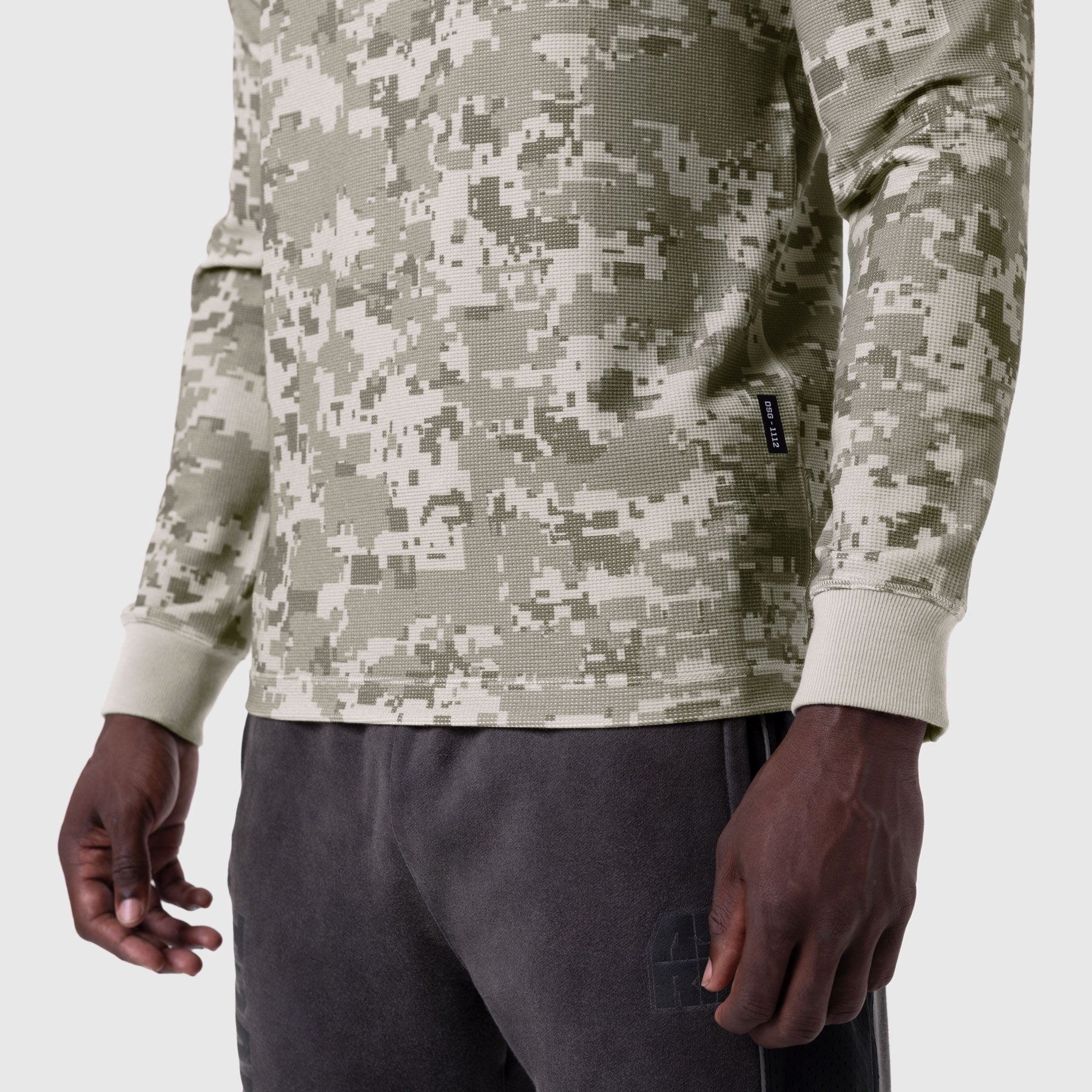 Waffle knit longsleeve in digital camo worn with dark joggers, cropped torso view