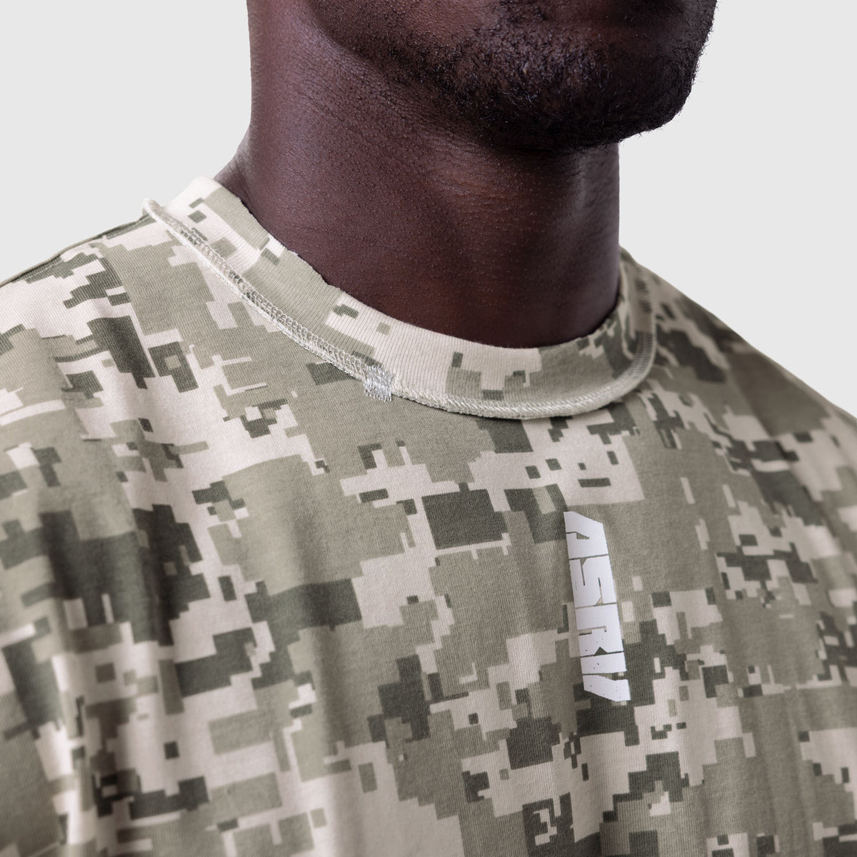 Tech Essential Cap Shoulder Cutoff in digital camo, worn by model, close-up view