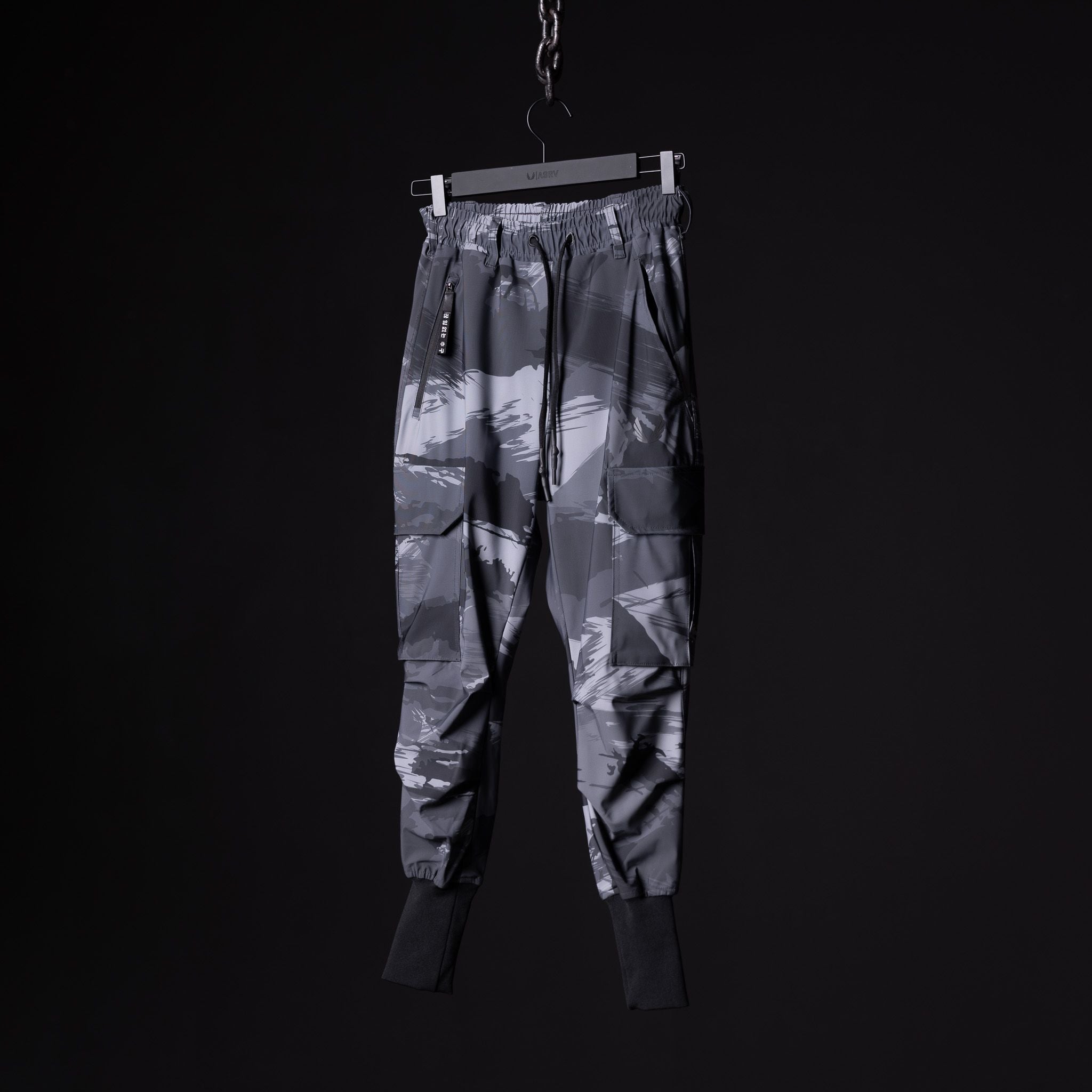 flatlay SM'20 Cargo High Rib joggers in grey camo, front view