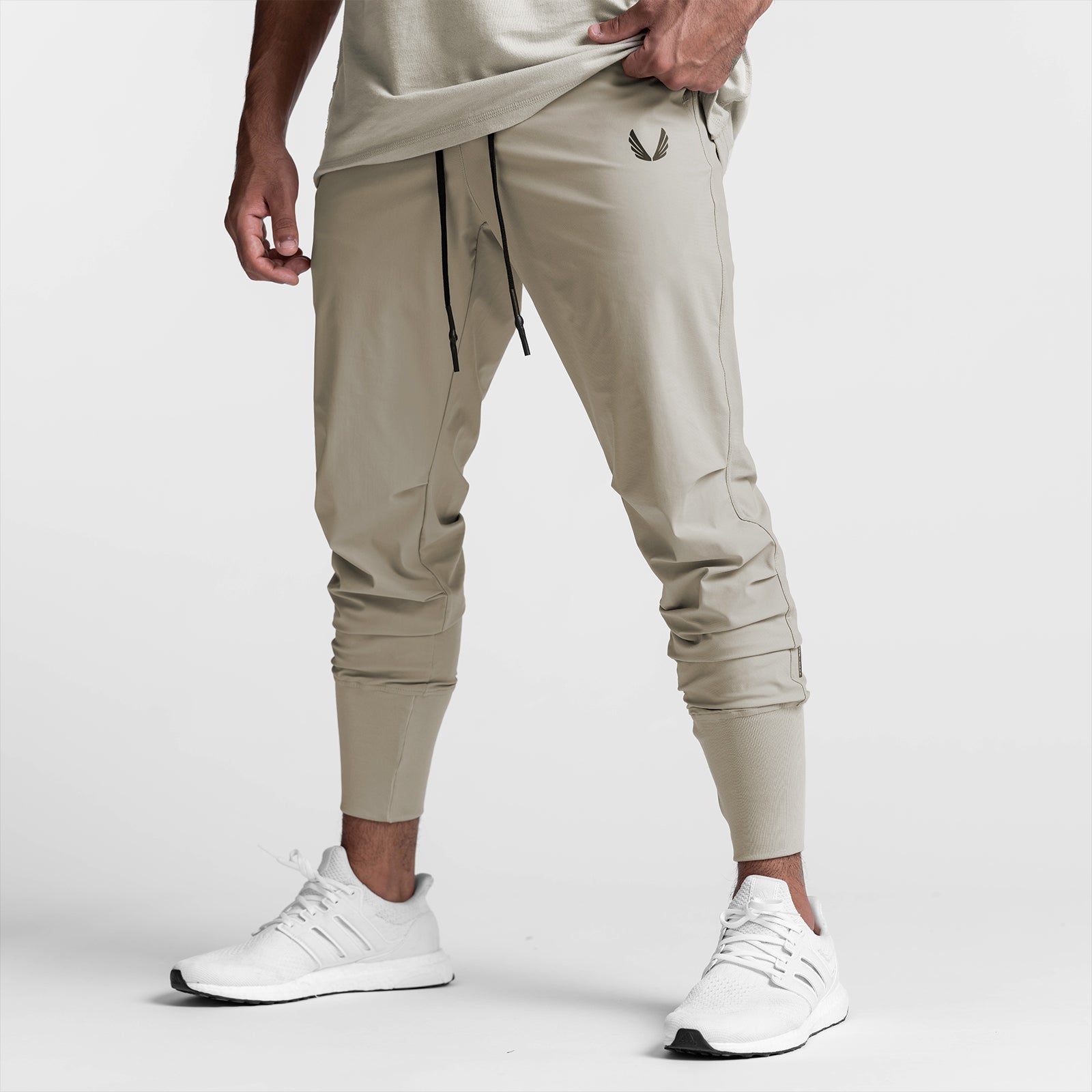 Tetra-Lite High Rib Jogger in sand smoke, worn by model with white sneakers, front view