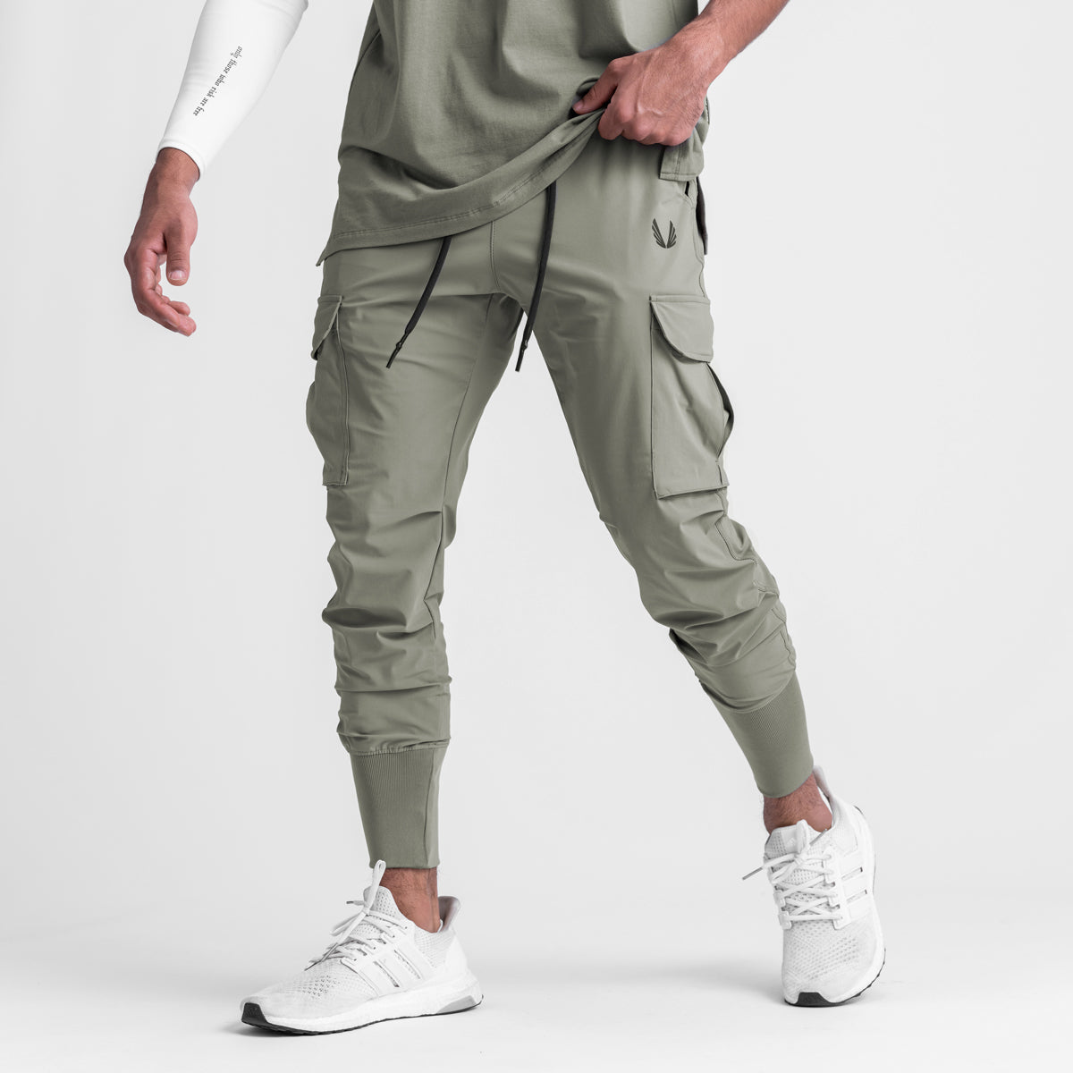 Tetra-Lite Cargo High Rib Jogger in sage, worn by model with white sneakers, front view