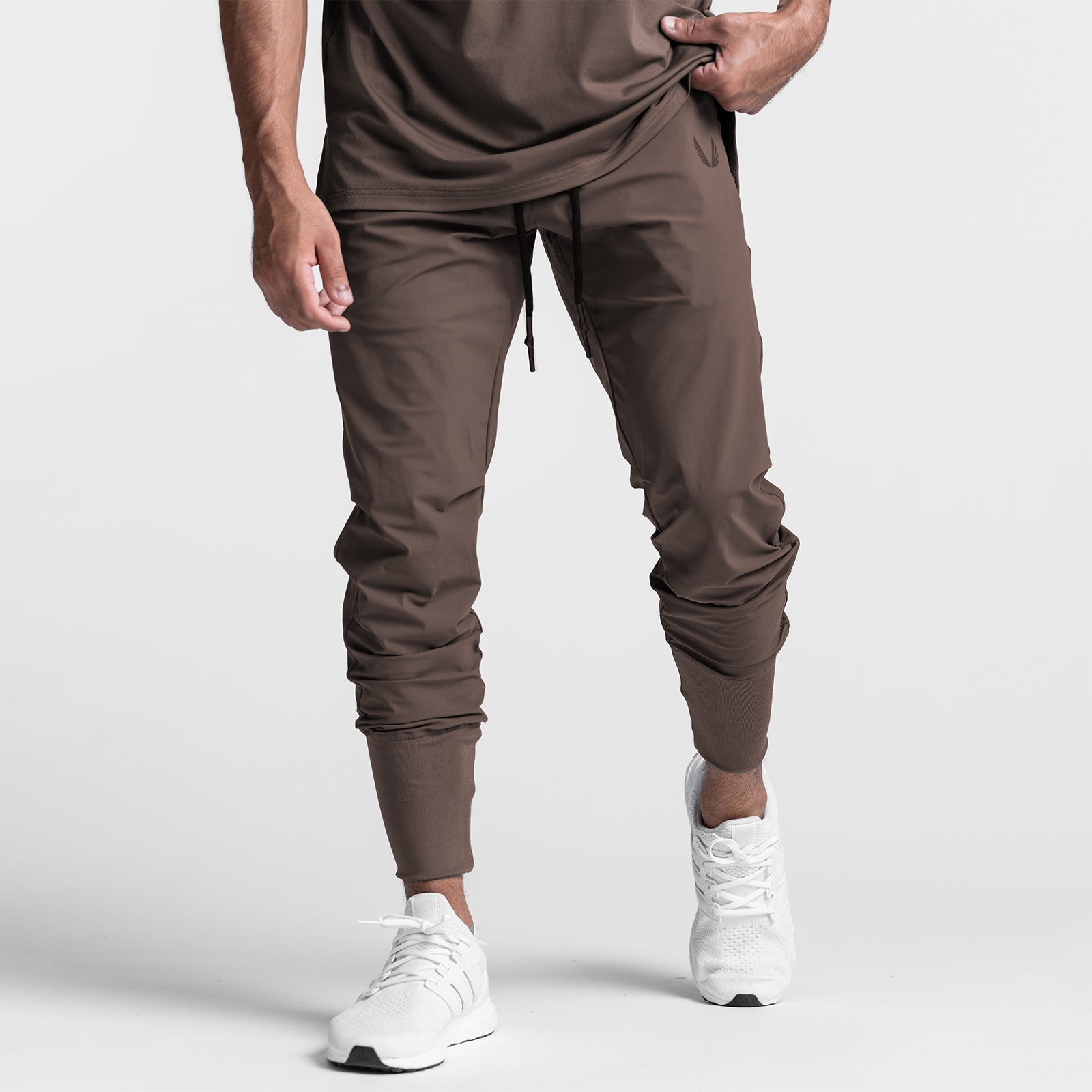 Tetra-Lite High Rib Jogger in deep taupe, worn with white sneakers, front view