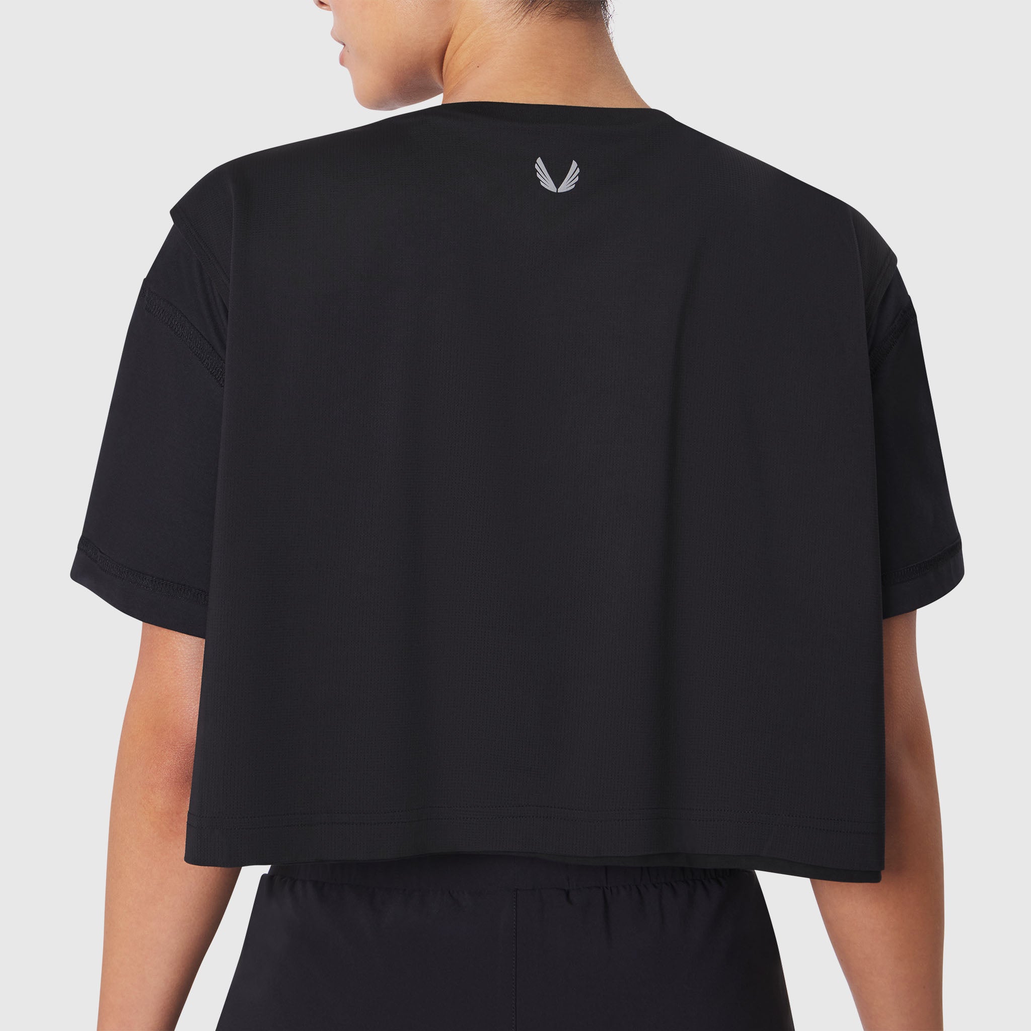 ASRV Supima Ice-Skin Reversible Crop Tee in black, back view on model