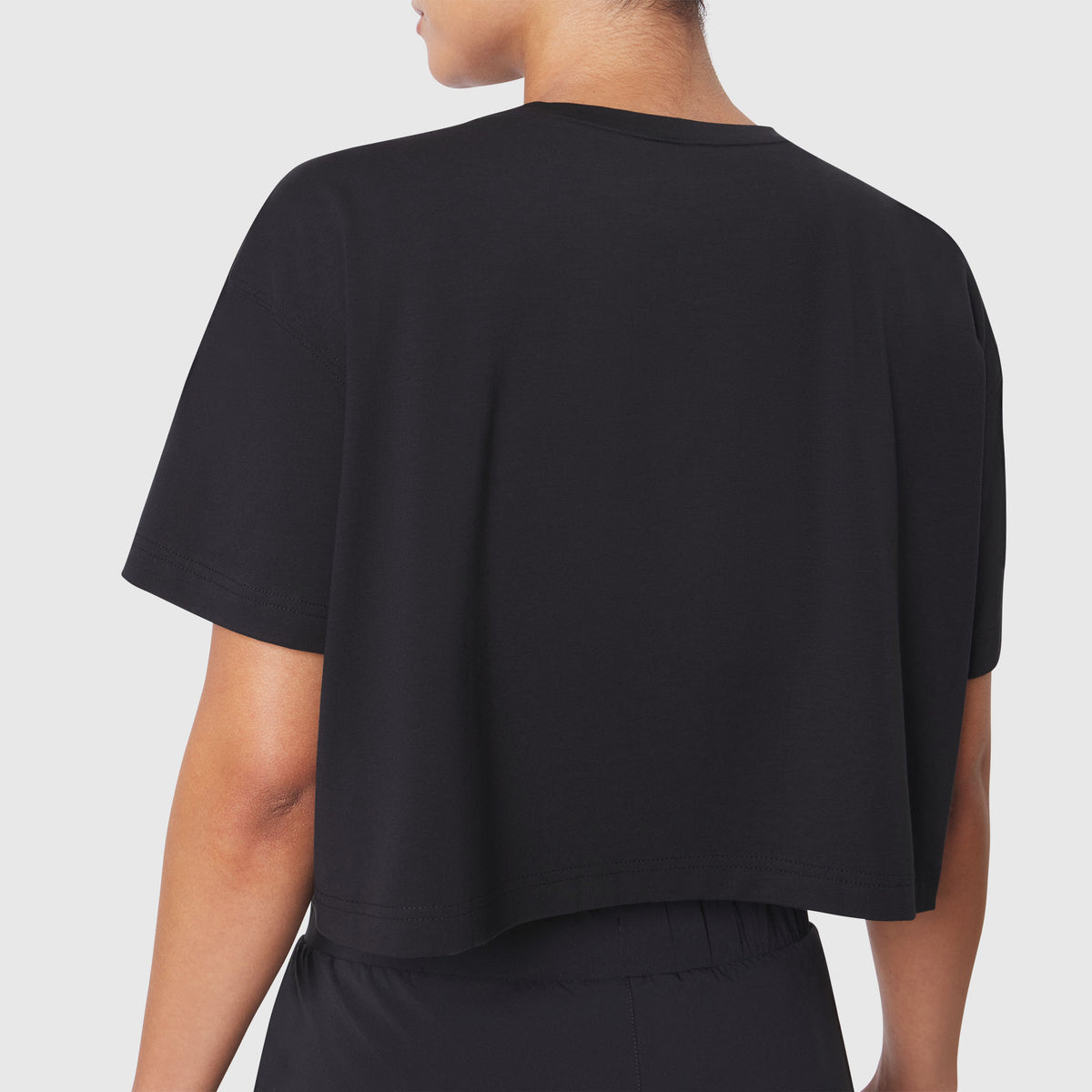 SUPIMA® Ice-Skin™ Reversible Crop Tee in Black, back view on model