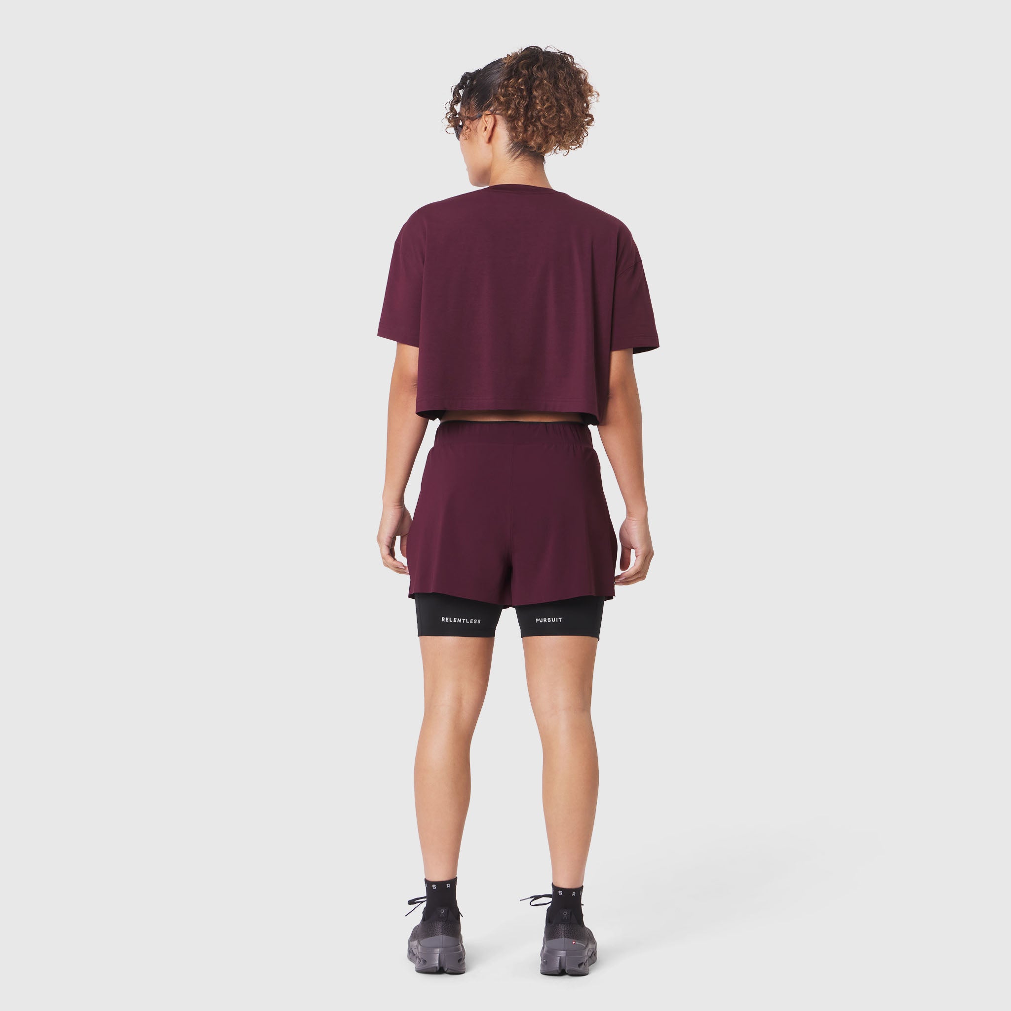 W082 Supima Ice-Skin Reversible Crop Tee in Merlot worn with black shorts, back view