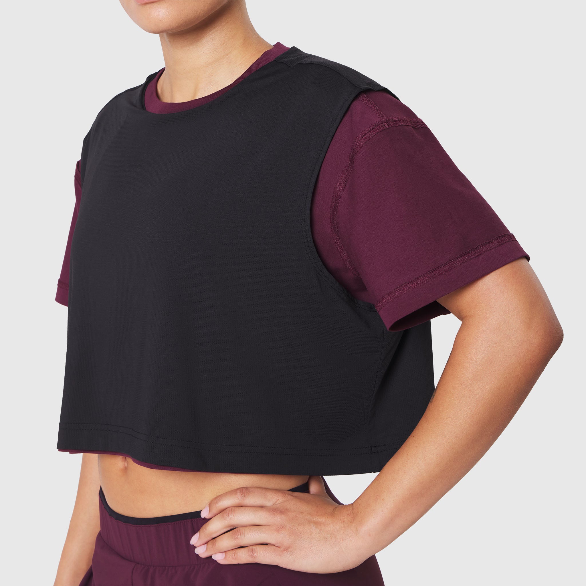 Reversible crop tee in merlot and black worn by model, front view