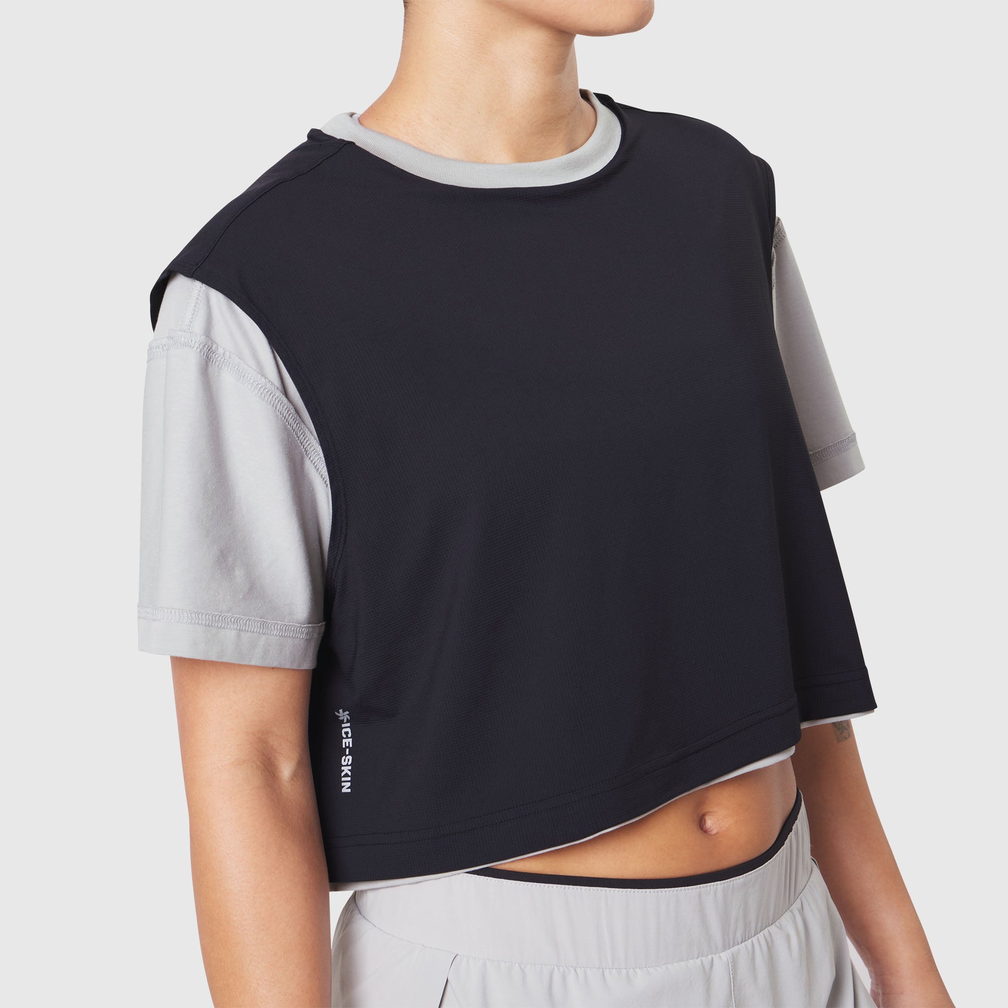 Reversible crop tee in slate grey and black, worn by model, front view