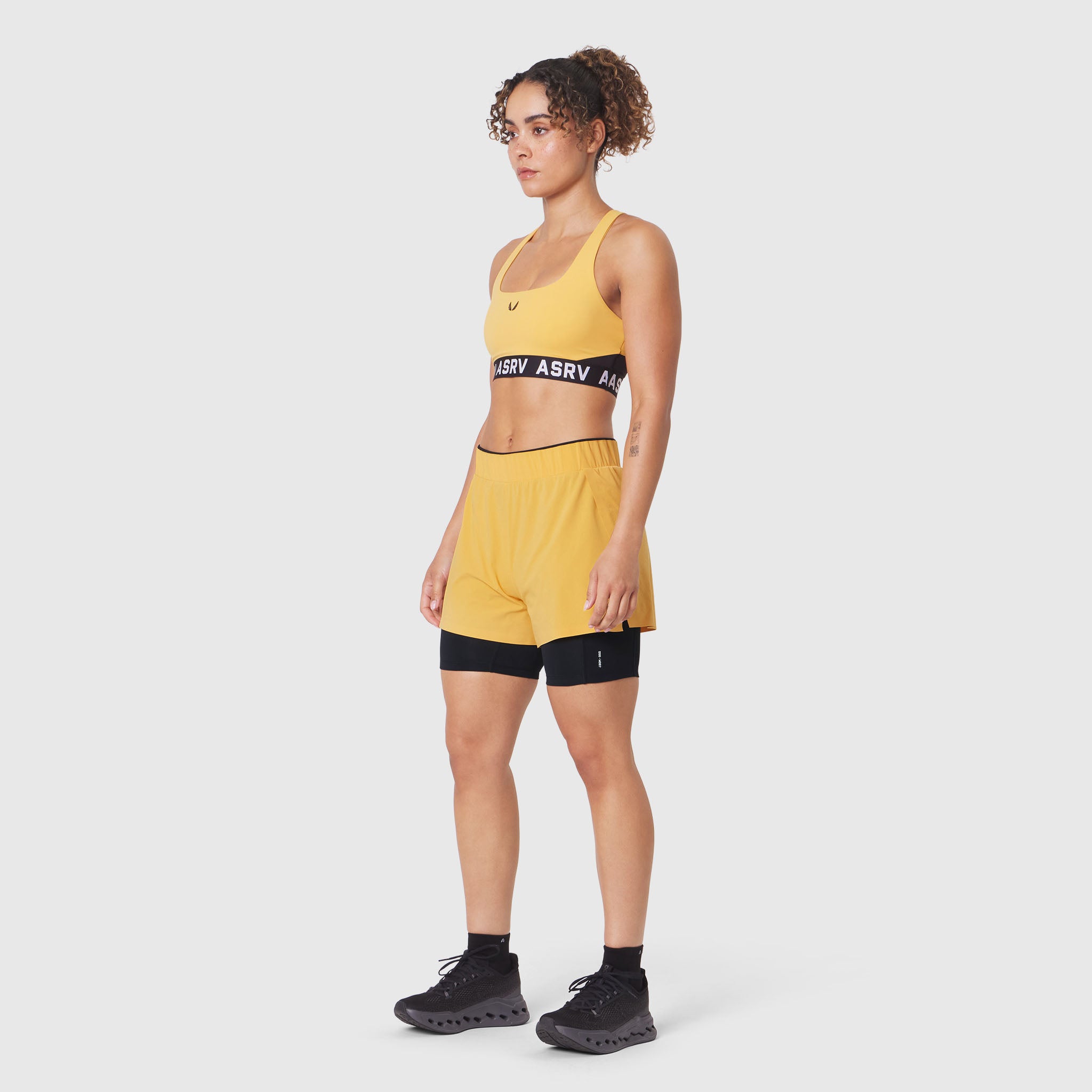 W083 LYCRA® ADAPTIV Racerback Sports Bra in Amber, worn by model, front view