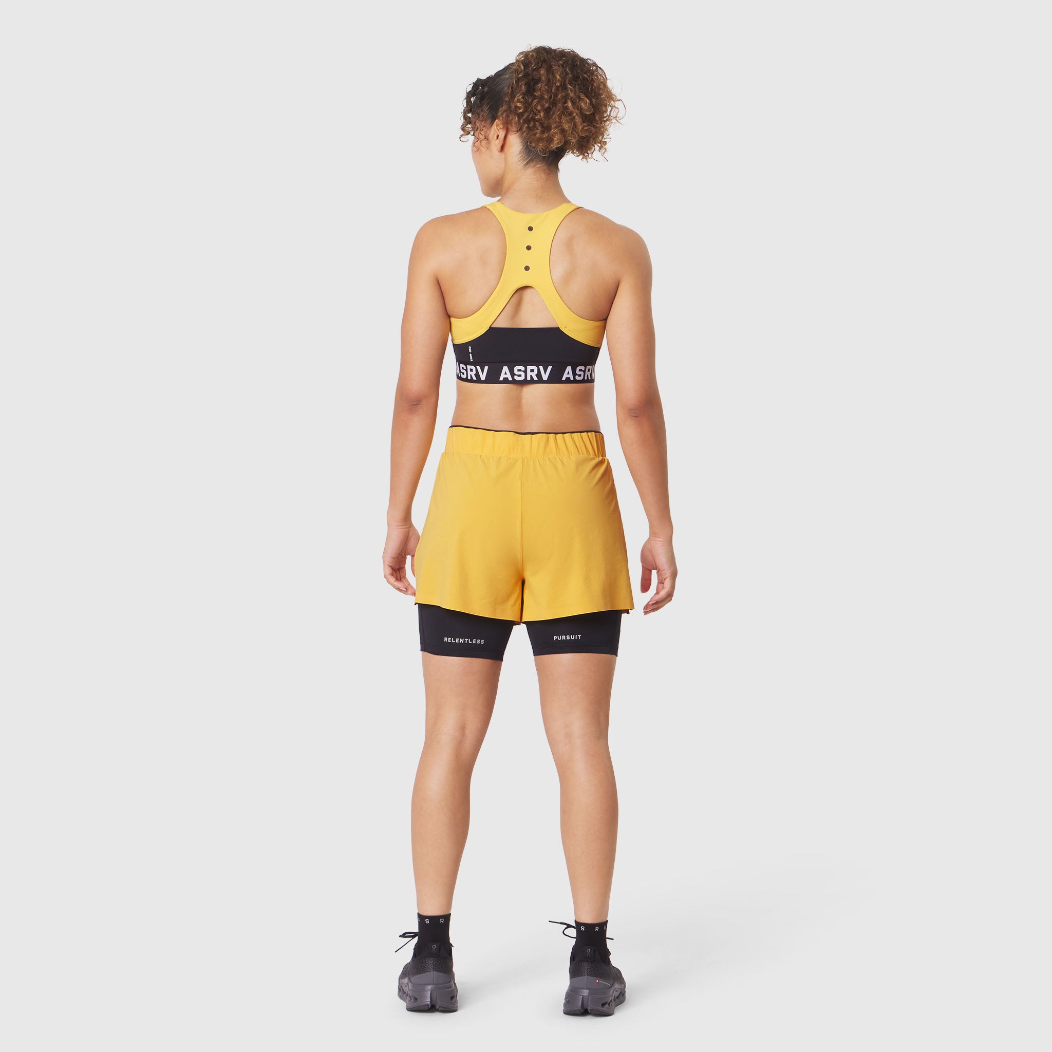 W083 LYCRA® ADAPTIV Racerback Sports Bra in amber, back view on model