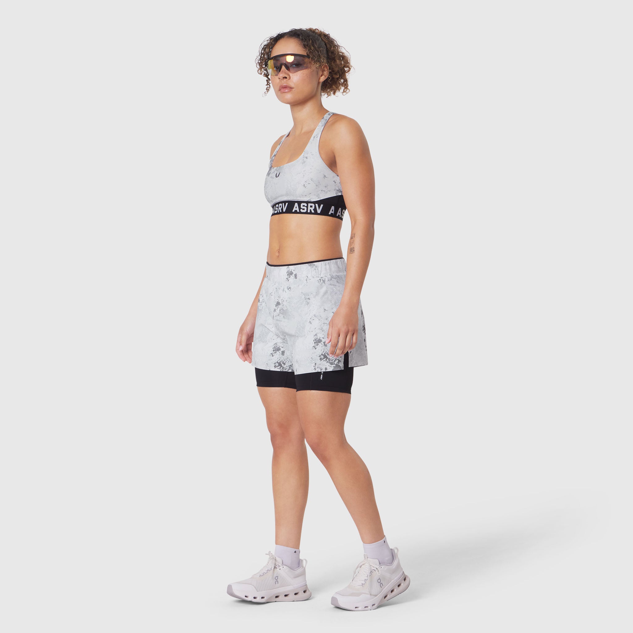 W083 LYCRA® ADAPTIV Racerback Sports Bra in Sedona Snow Camo, worn by model