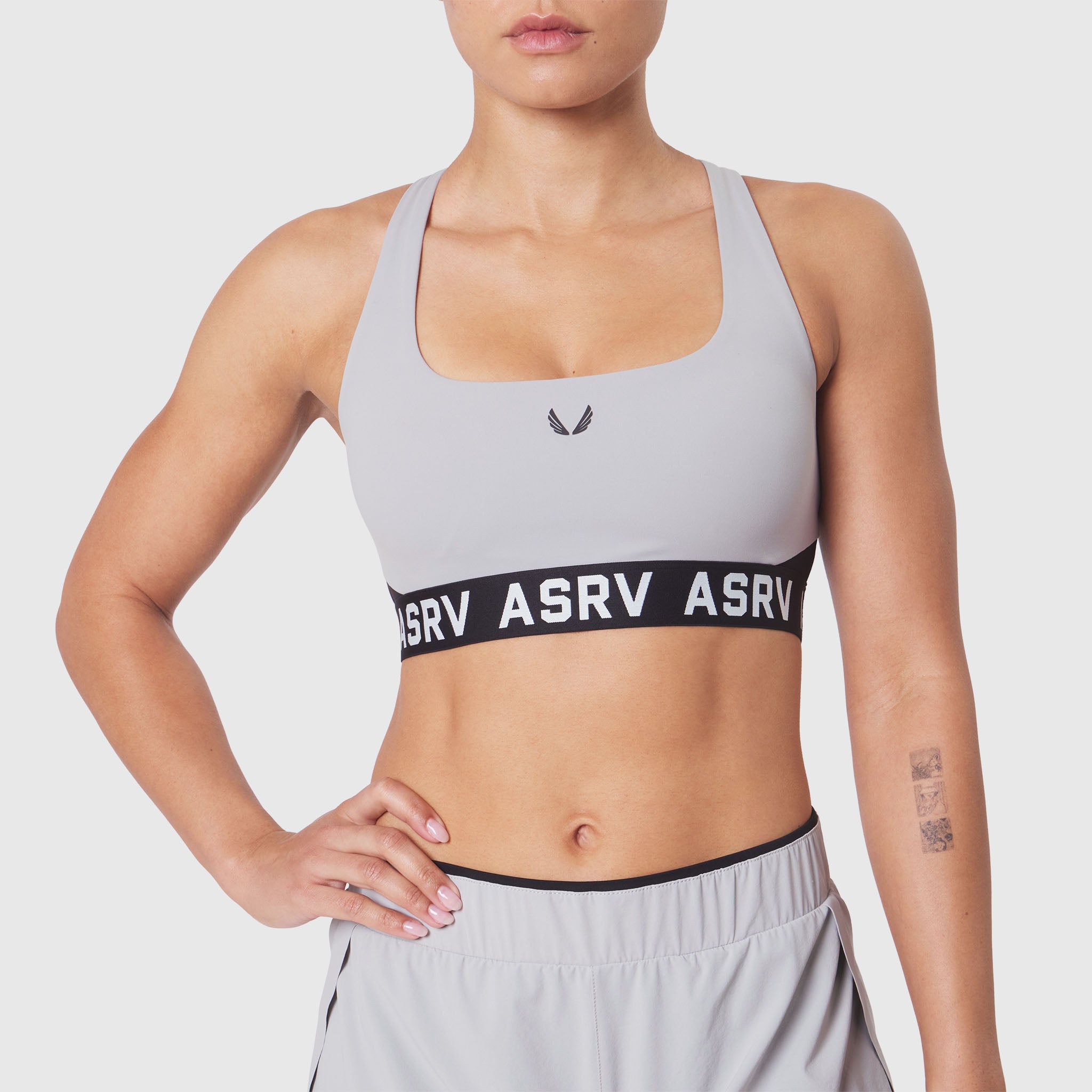 W083 LYCRA® ADAPTIV Racerback Sports Bra in Slate Grey, front view on model