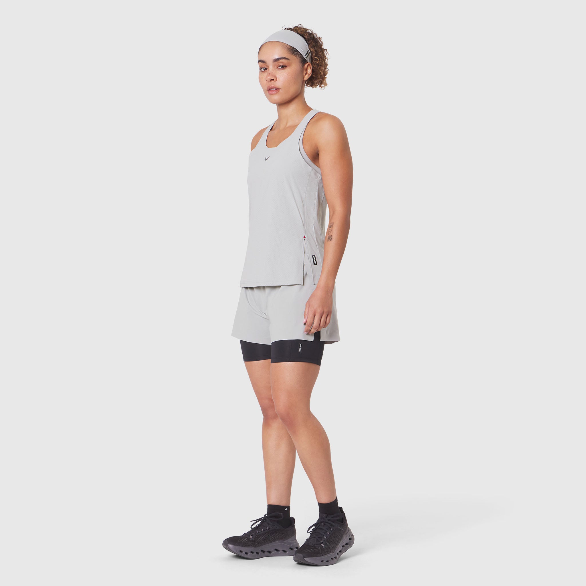 Aerotex™ Perforated Run Tank in Slate Grey, worn with matching shorts and black bike shorts, front view