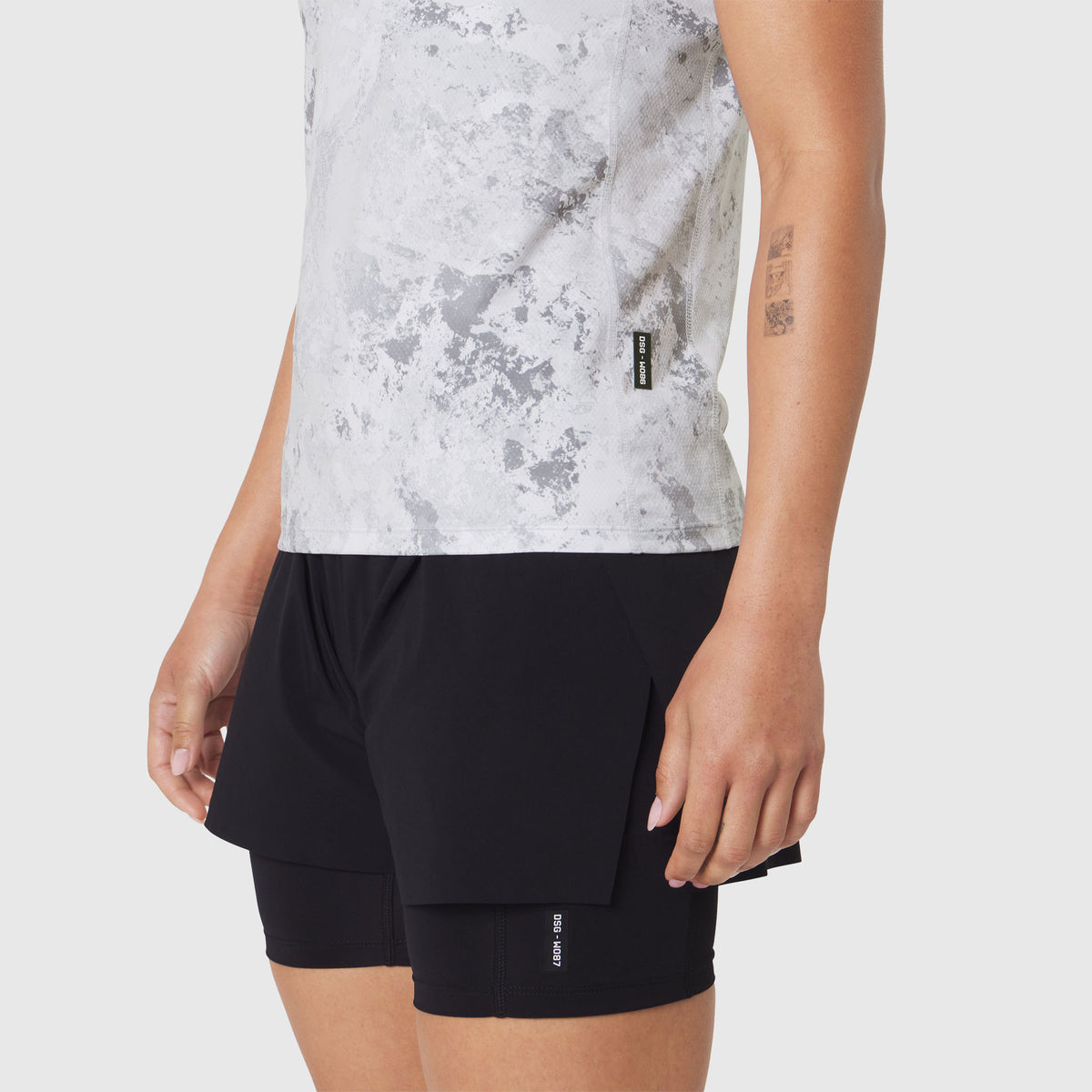 AEROSILVER® UPF50+ Run Tee in Sedona Snow Camo worn with black shorts, side view