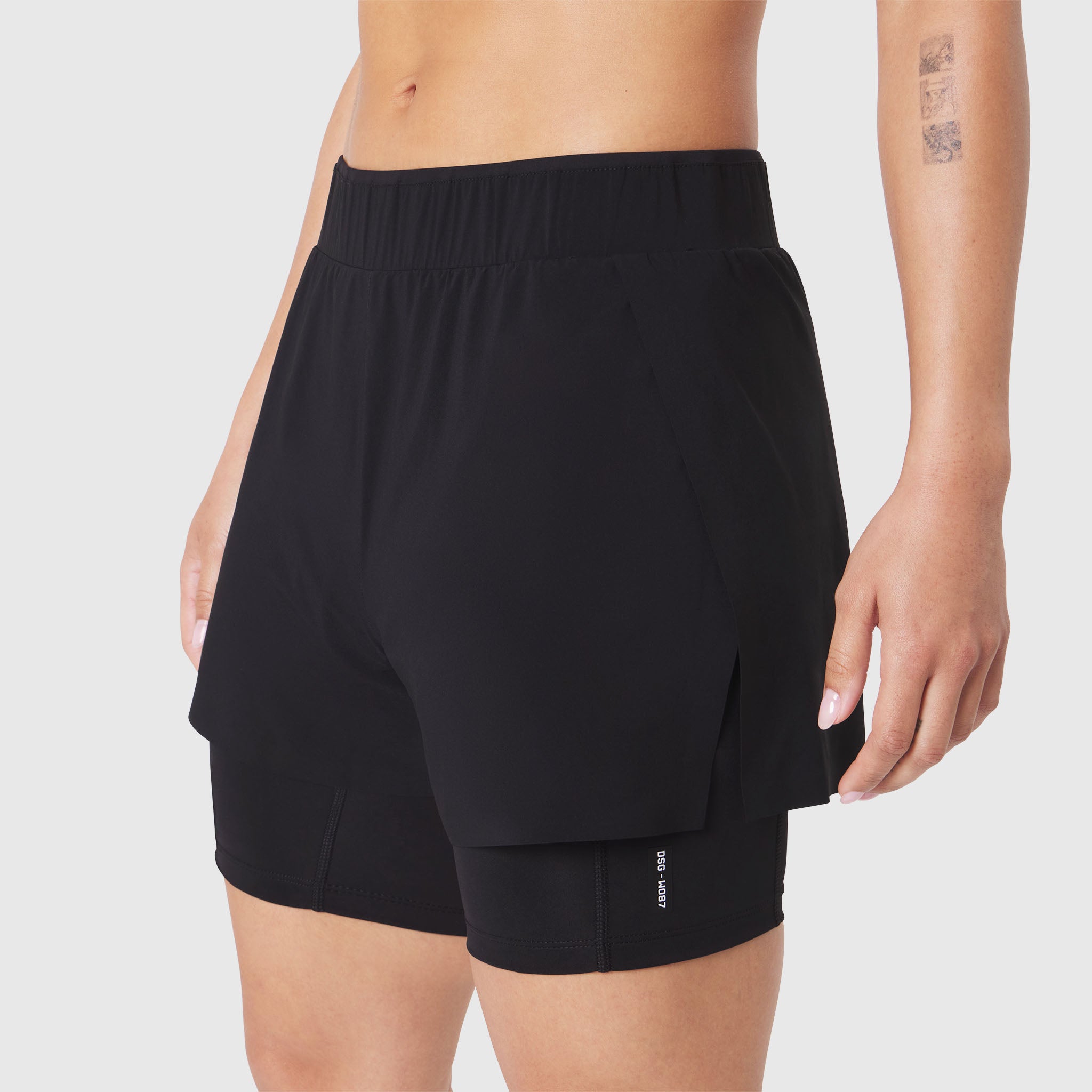 W087 Aerotex Side Split Liner Short in Black, worn by model, side view