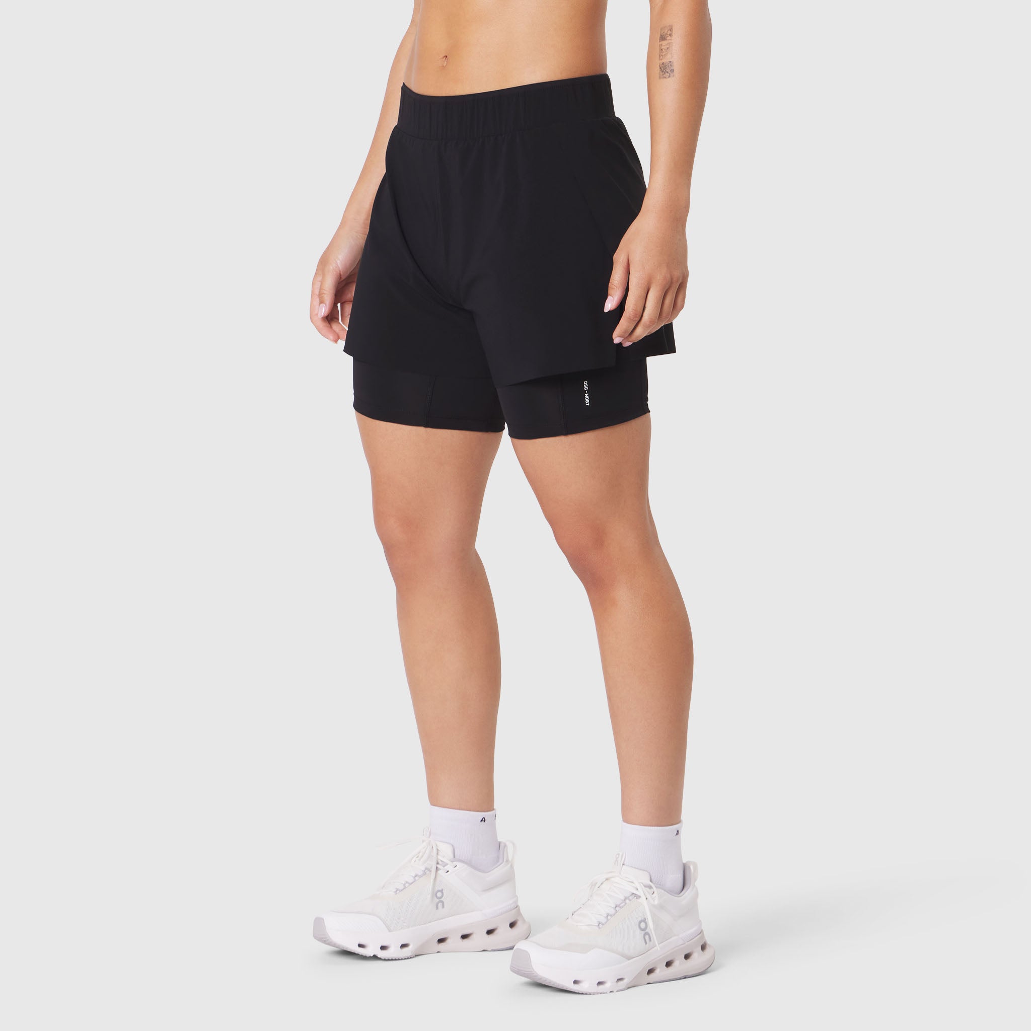 W087 Aerotex Side Split Liner Short in Black, worn by model in side view
