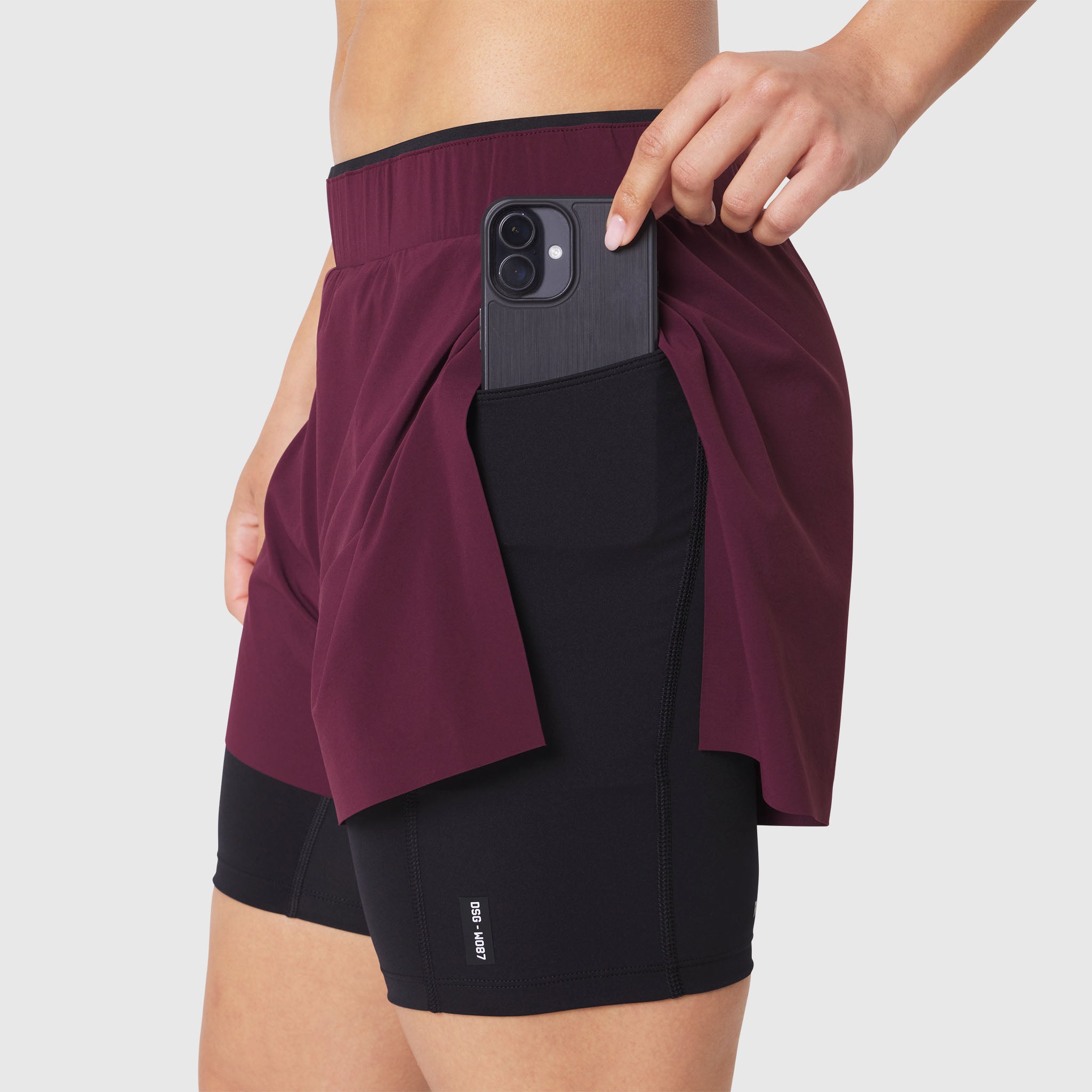 W087 Aerotex Side Split Liner Short in Merlot, worn by model showing phone pocket detail