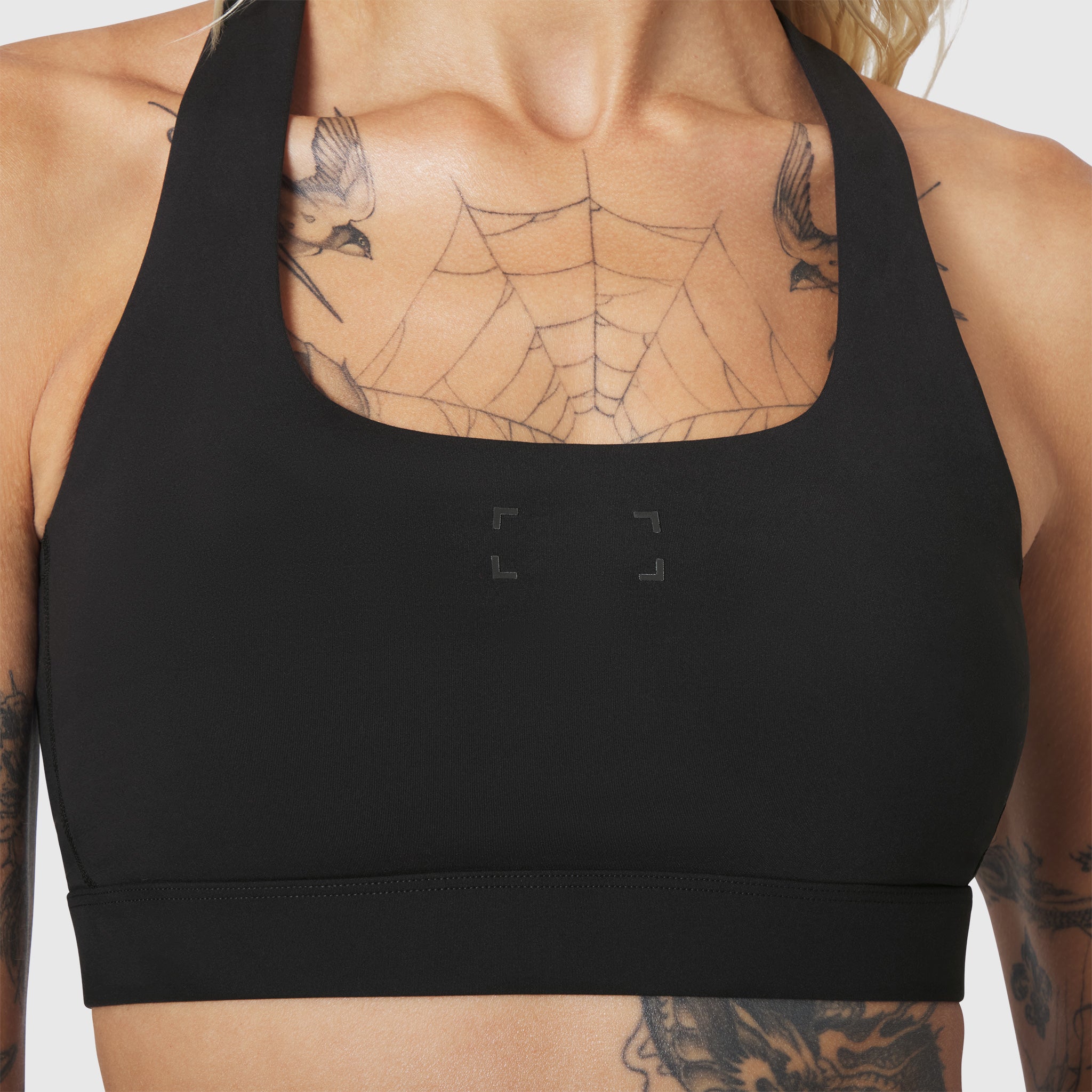 W096 LYCRA® ADAPTIV Racerback Sports Bra in black, front view on model
