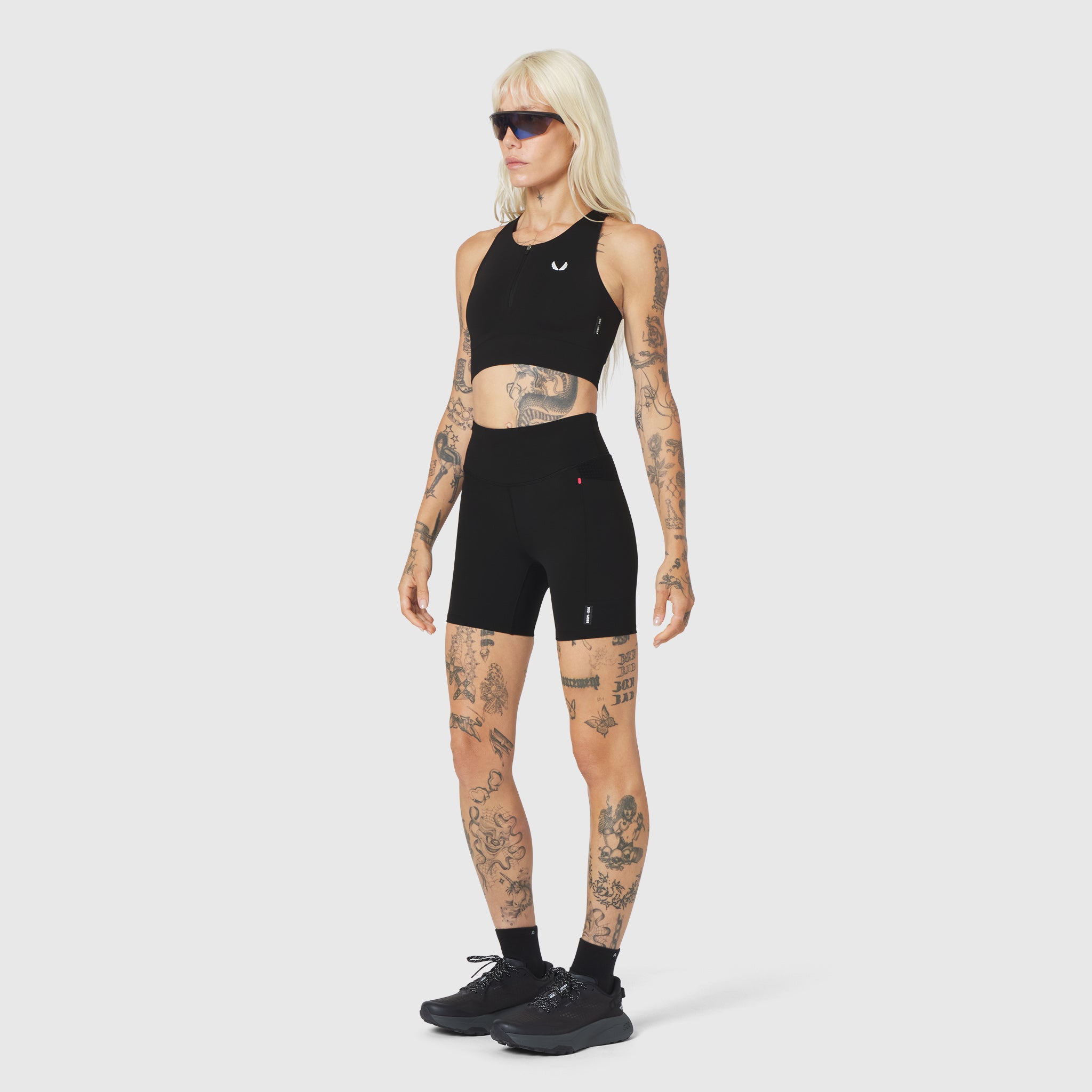 W097 LYCRA® ADAPTIV Seamless Zip Bra in black, worn with matching shorts