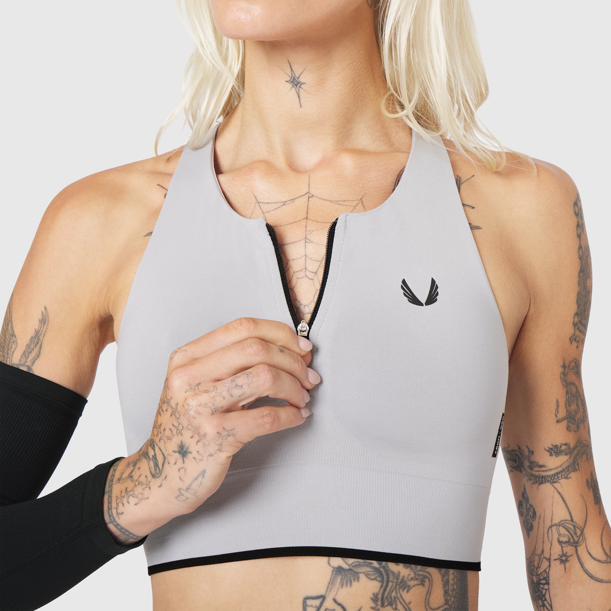 W097 LYCRA® ADAPTIV Seamless Zip Bra in slate grey, front view on model