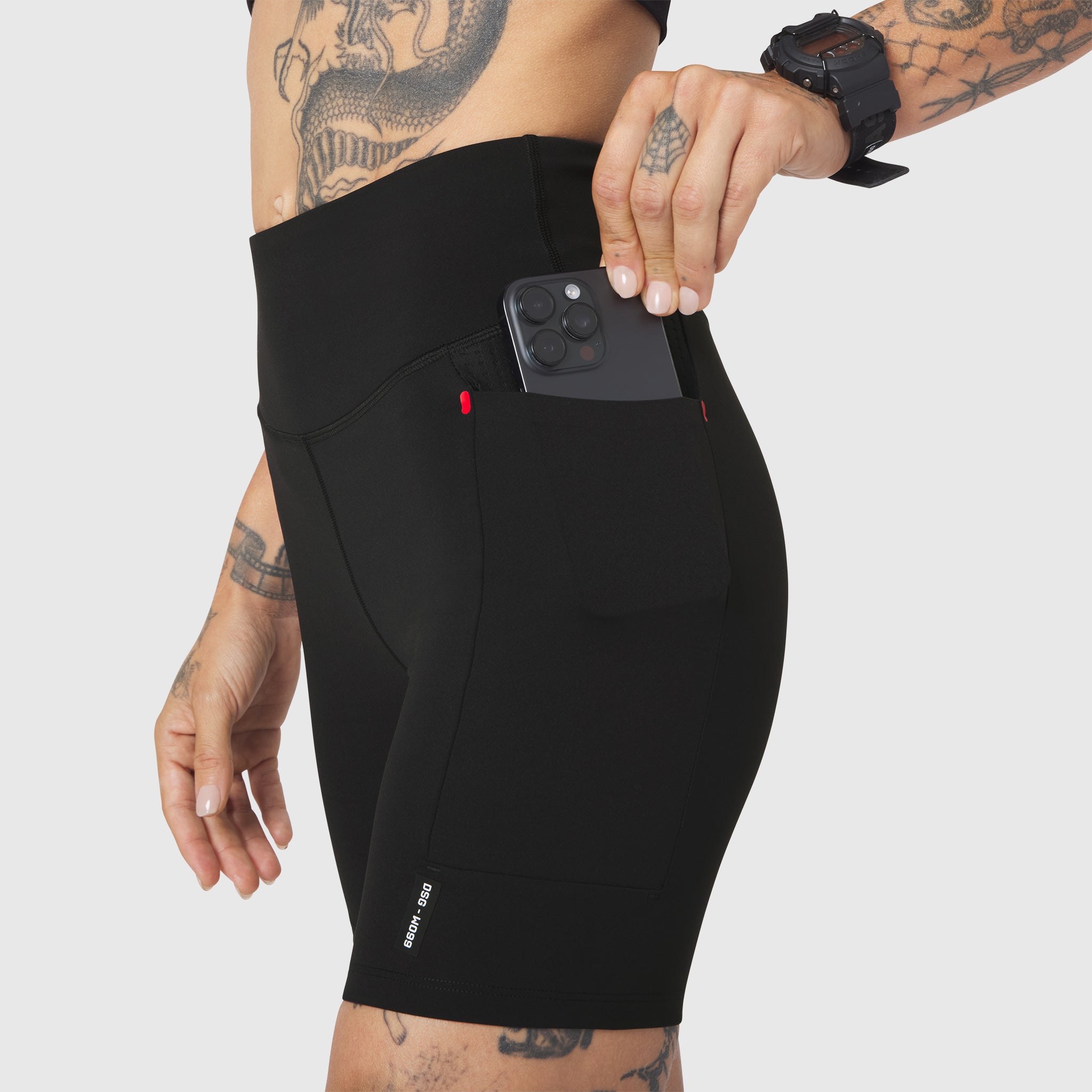 W099 LYCRA® ADAPTIV Hybrid Bike Short in Black, worn by model with phone in pocket