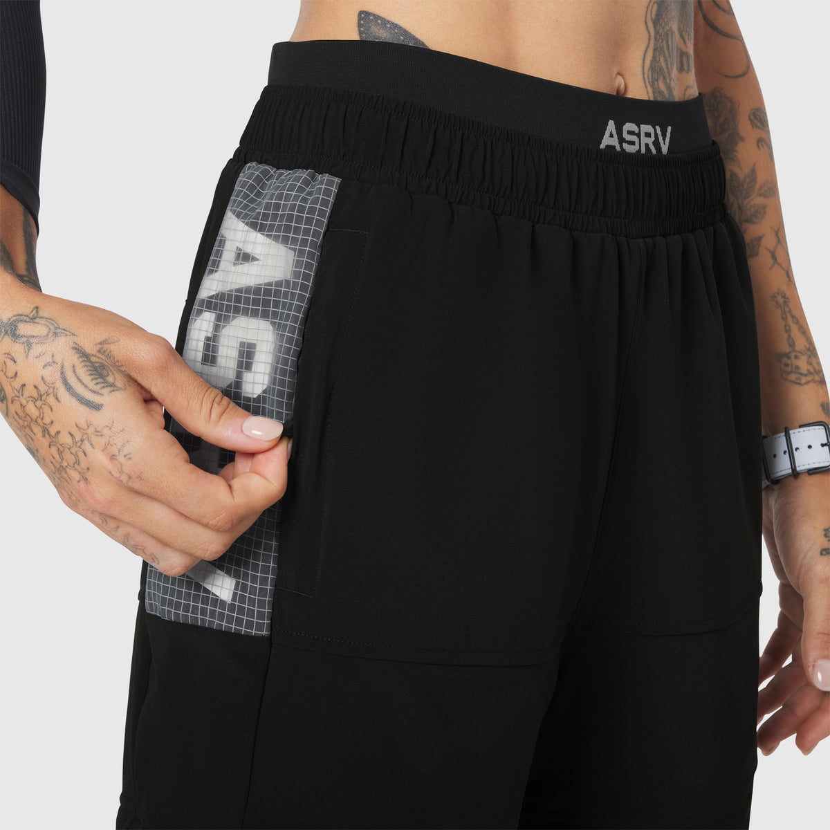 W100 2-in-1 Convertible Pant in Black, worn by model showing side pocket detail