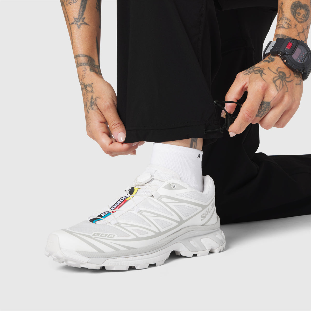 W100 2-in-1 Convertible Pant in black worn by model with white sneaker