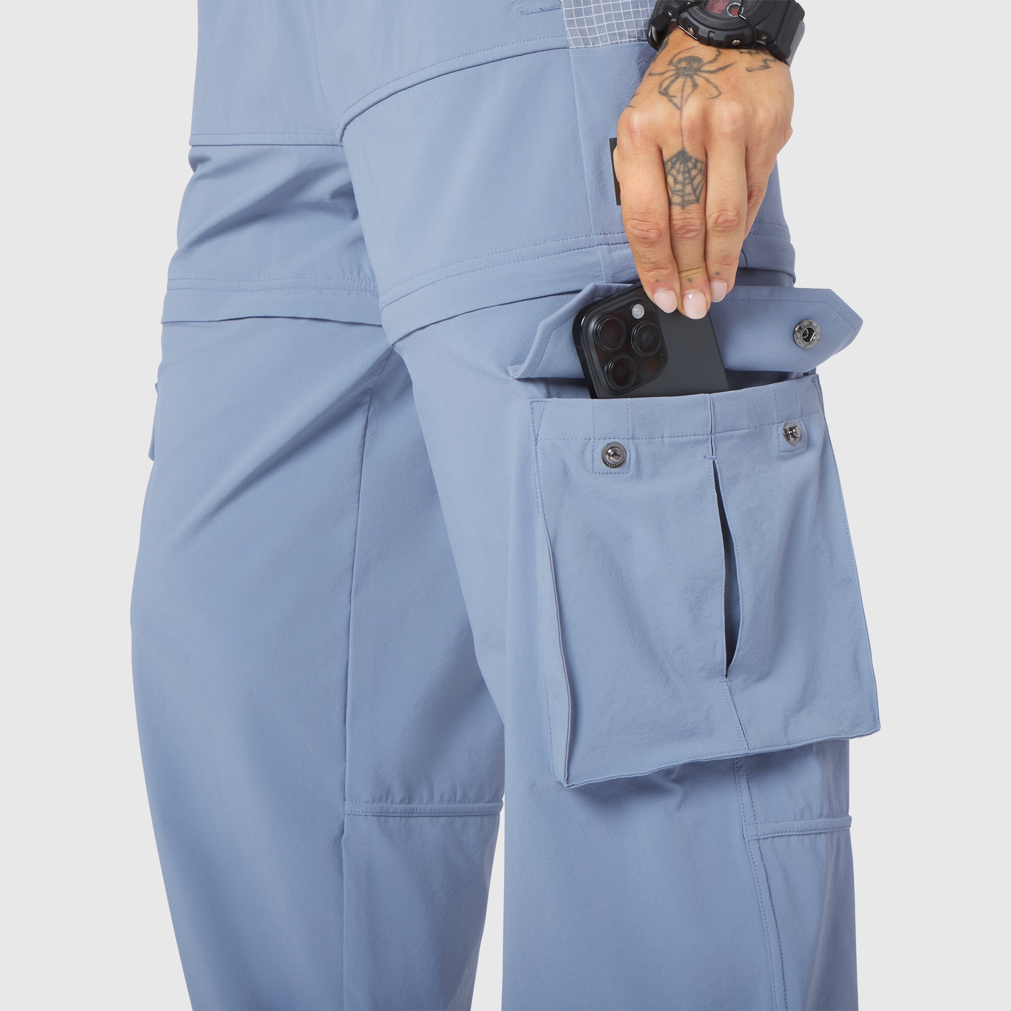 W100 2-in-1 Convertible Pant in Slate Blue, worn with phone in pocket