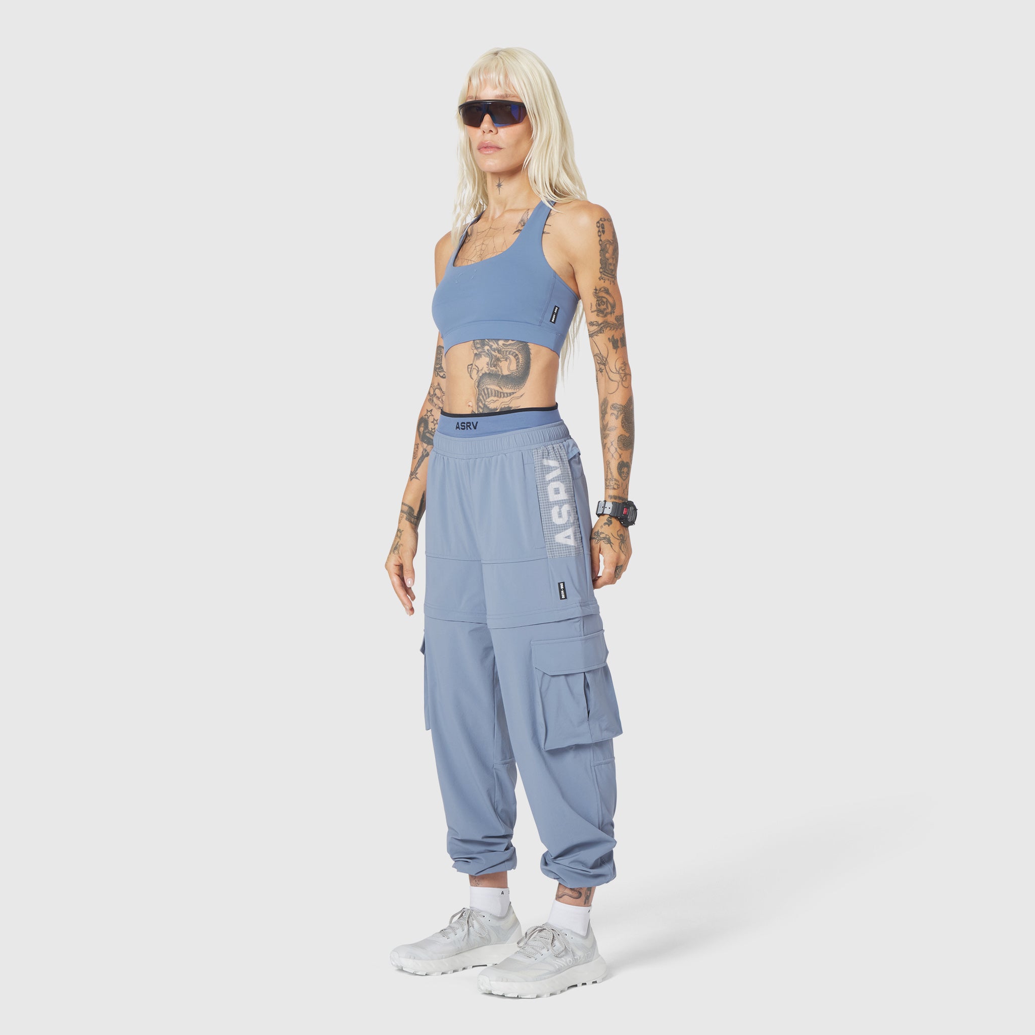 W100 2-in-1 Convertible Pant in Slate Blue, worn by model standing against white background