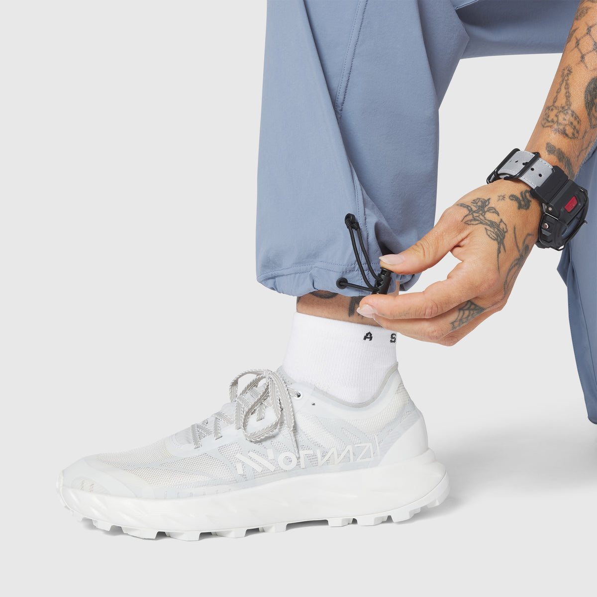 W100 2-in-1 Convertible Pant in Slate Blue, worn with white sneakers