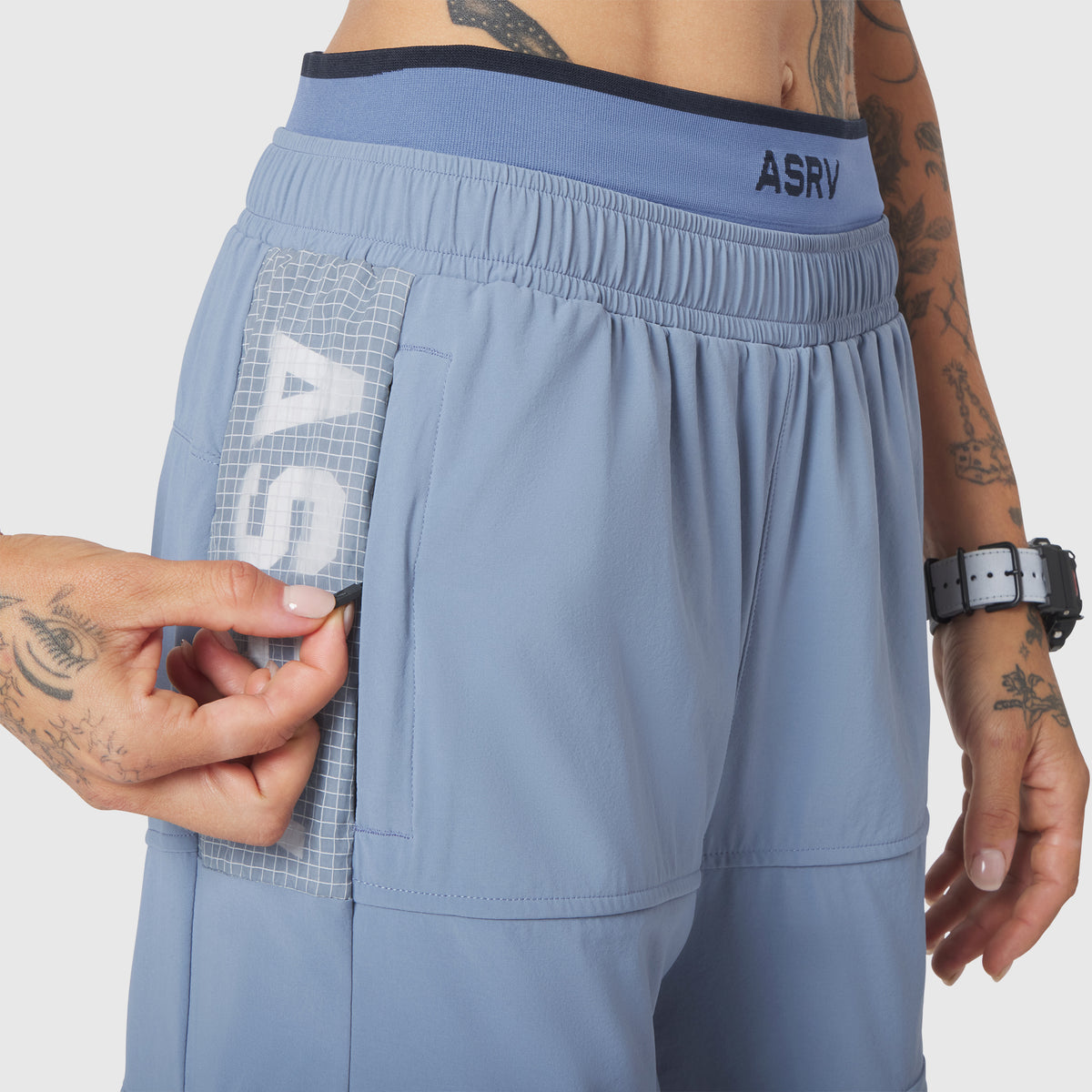 W100 2-in-1 Convertible Pant in Slate Blue, worn with cargo pocket detail visible
