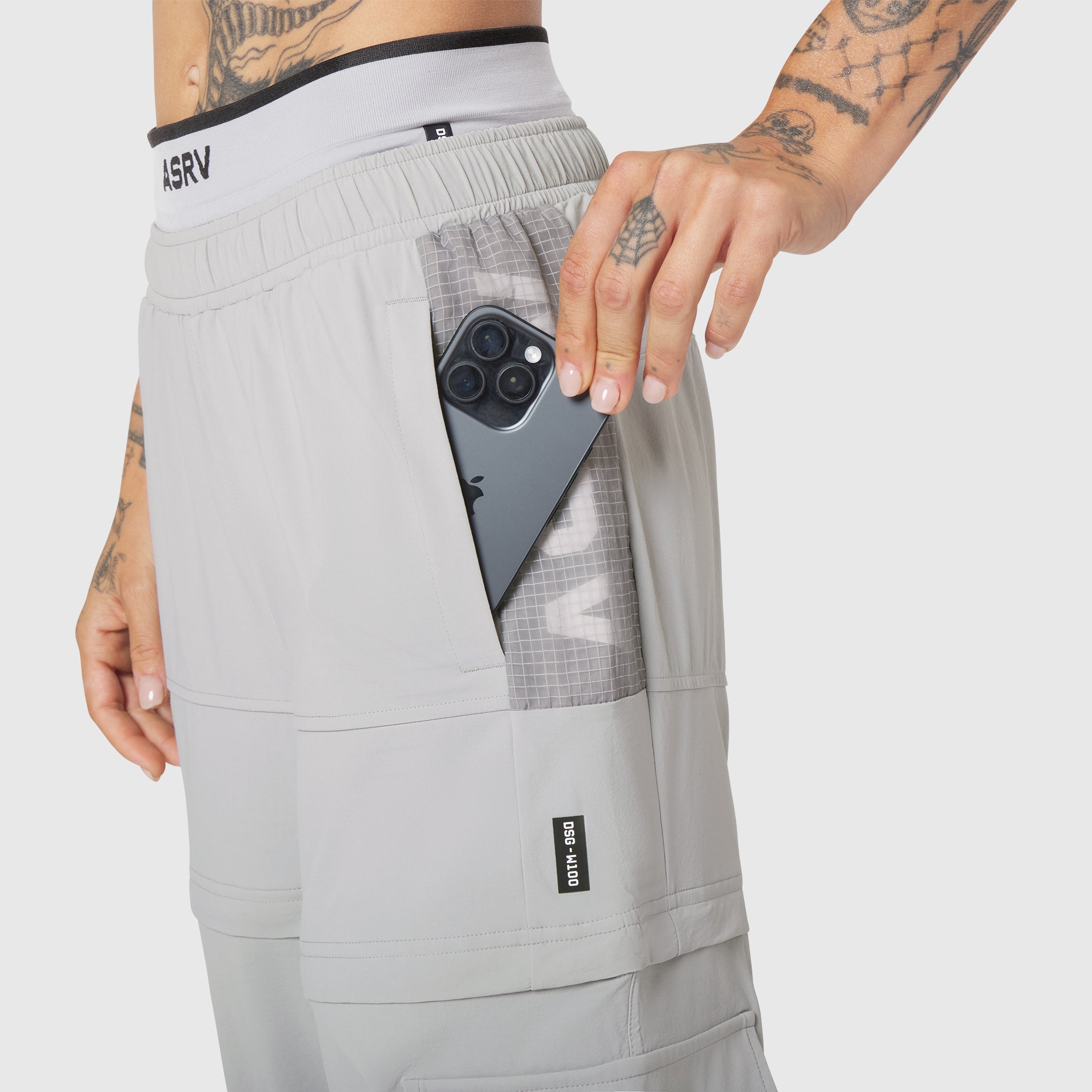 W100 2-in-1 Convertible Pant in Slate Grey worn by model, side view with phone in pocket