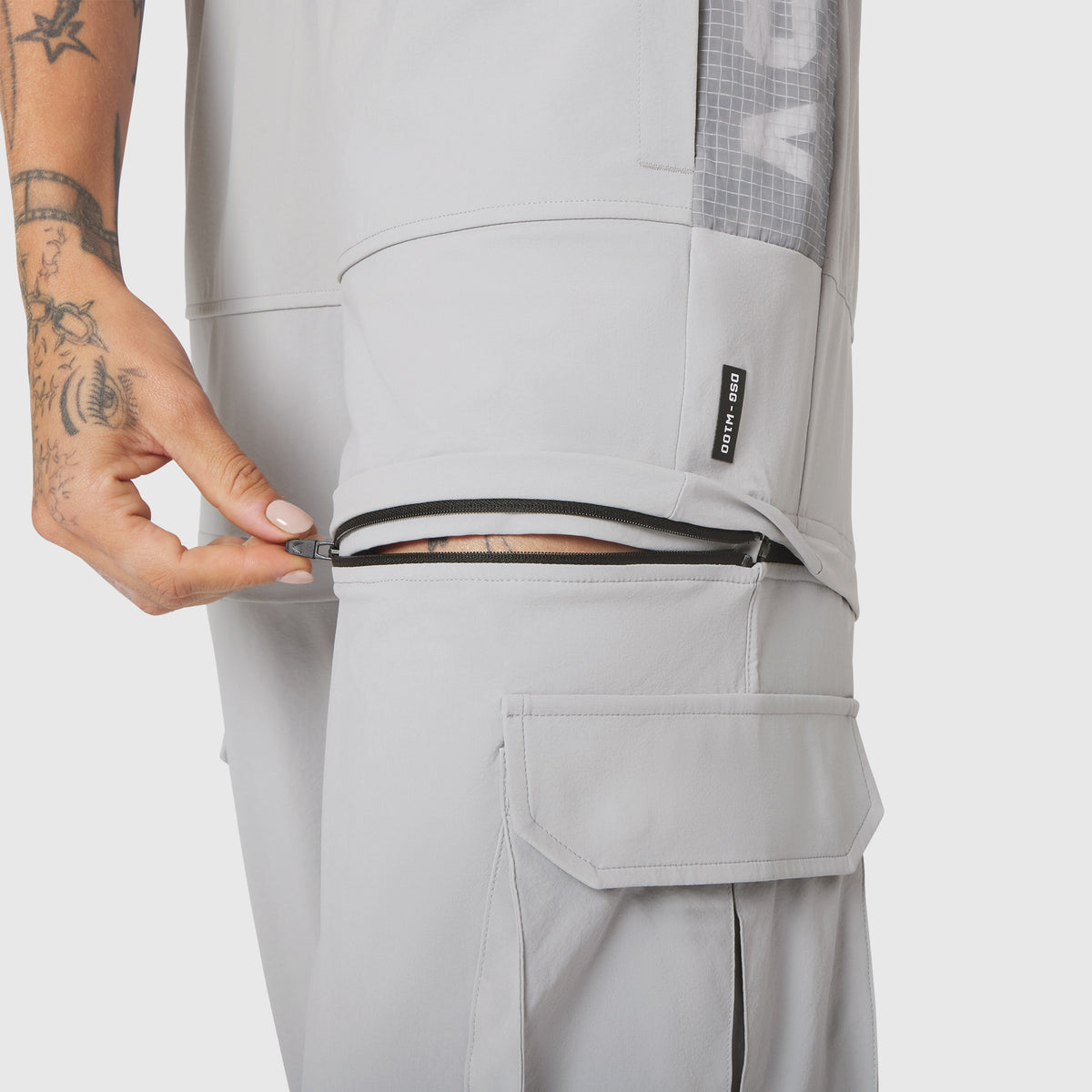 W100 2-in-1 Convertible Pant in Slate Grey, worn with zip pocket detail visible