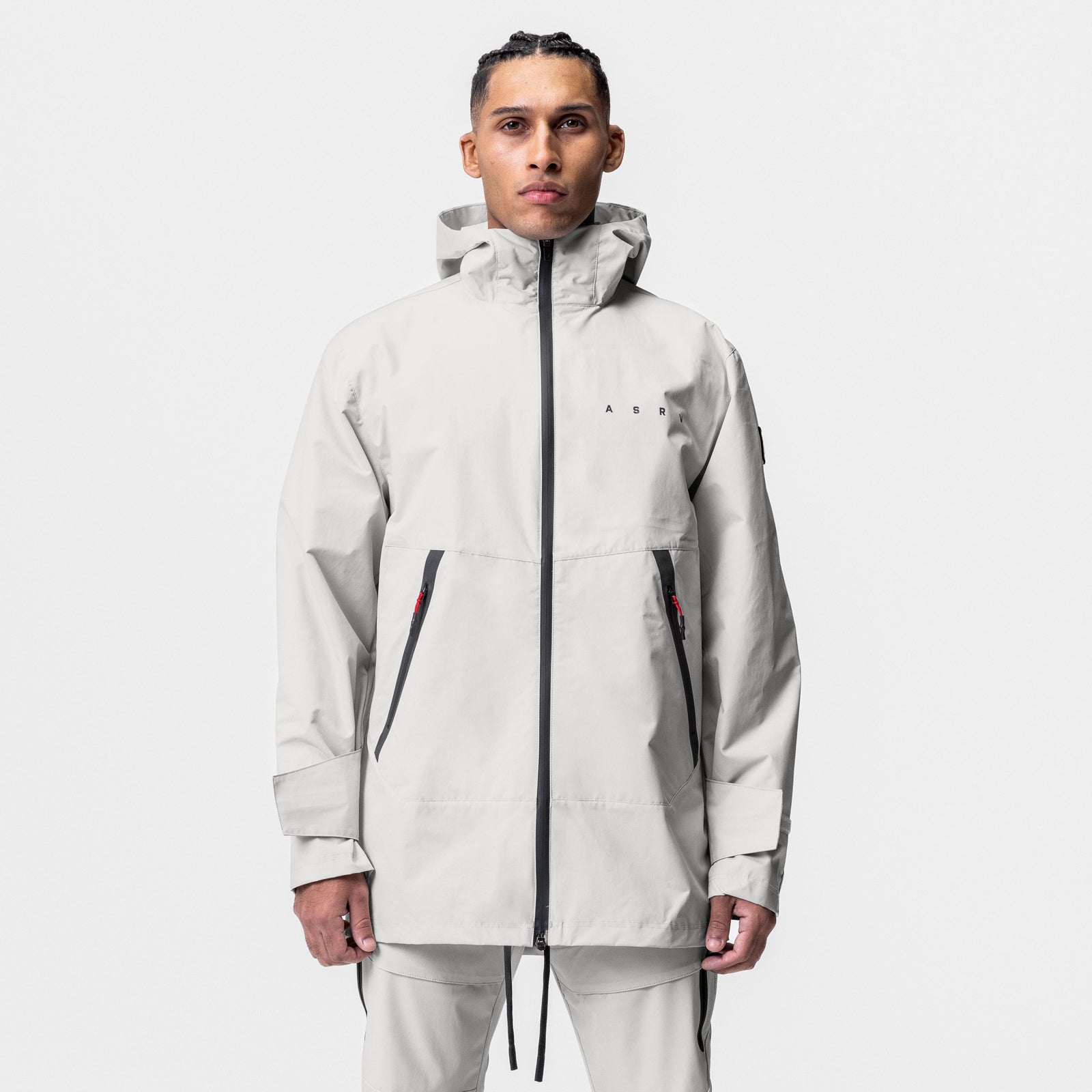 Hipora® Tech Parka in stone, worn by model in front view with hood up