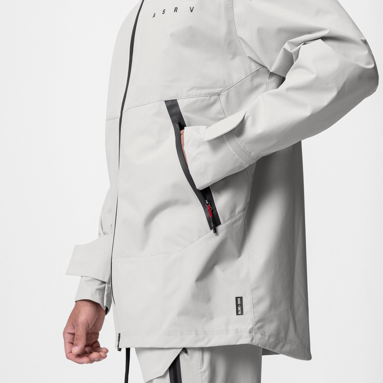 Hipora® Tech Parka in stone worn by model, side view showing zipper and pocket details