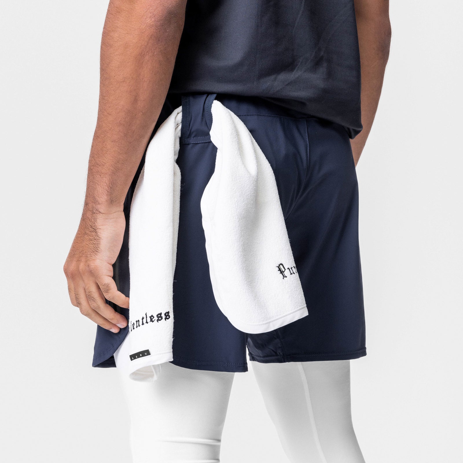 Tetra-Lite® 7" Tech Short in navy, modeled from side angle with white towel