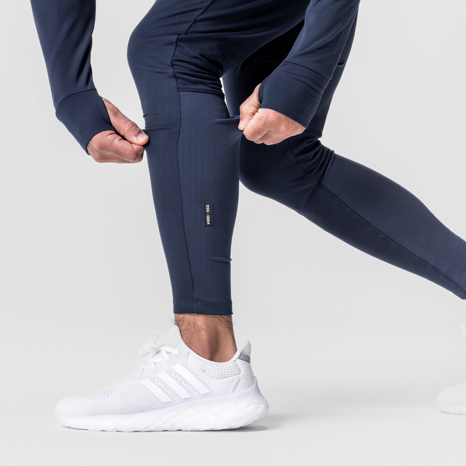 Thermal Hybrid Jogger in navy worn by model with white sneakers, leg detail