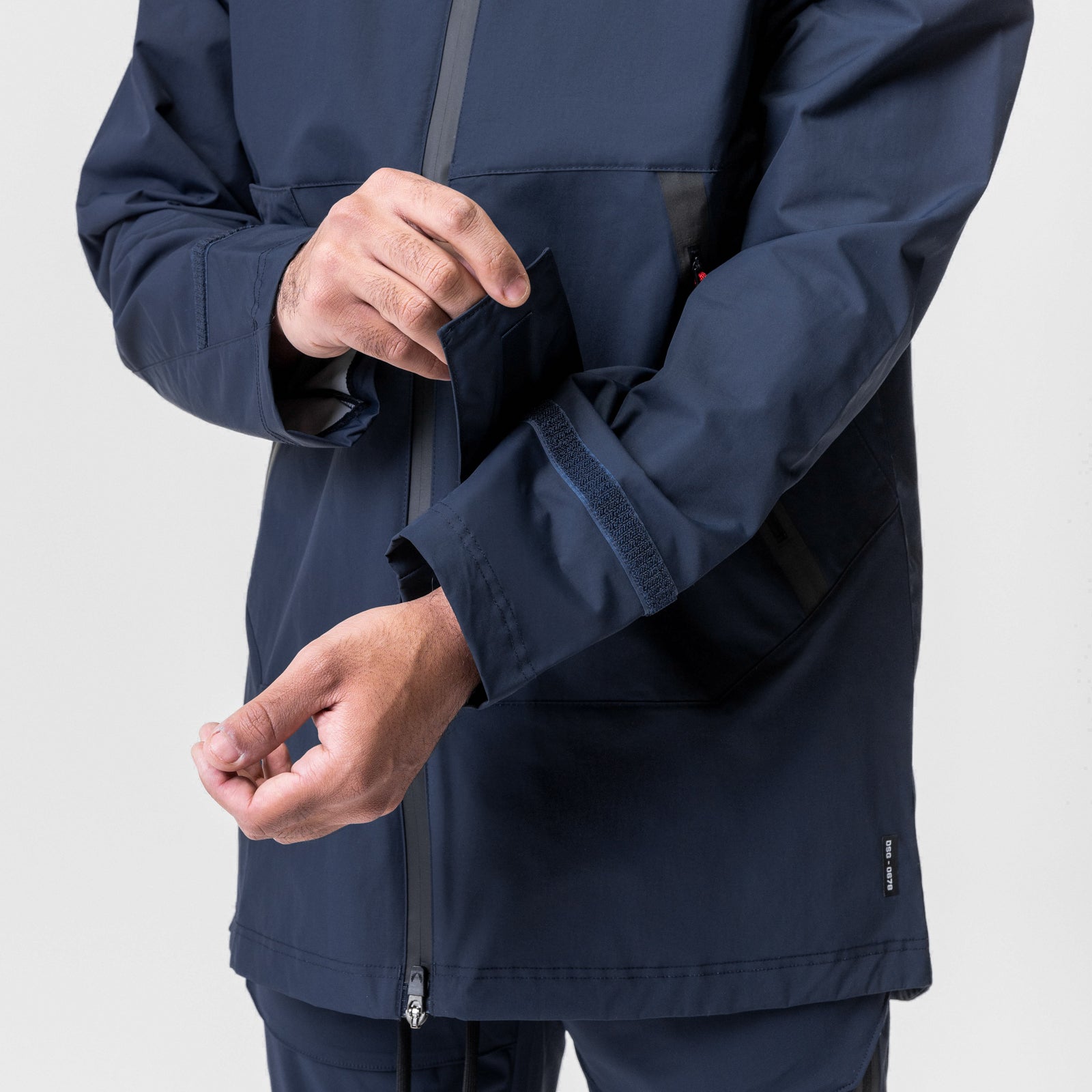 Navy Hipora Tech Parka worn by model, showing sleeve cuff and zipper detail