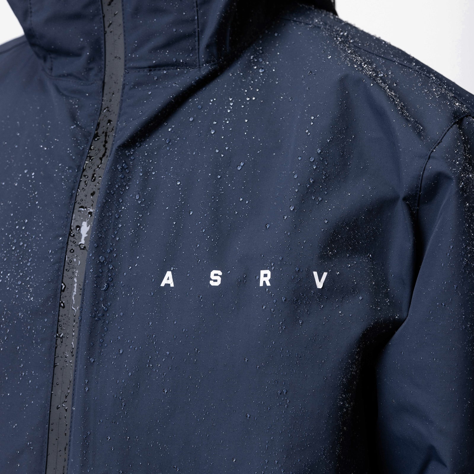 Hipora® Tech Parka in navy with water beads, worn on model, front view